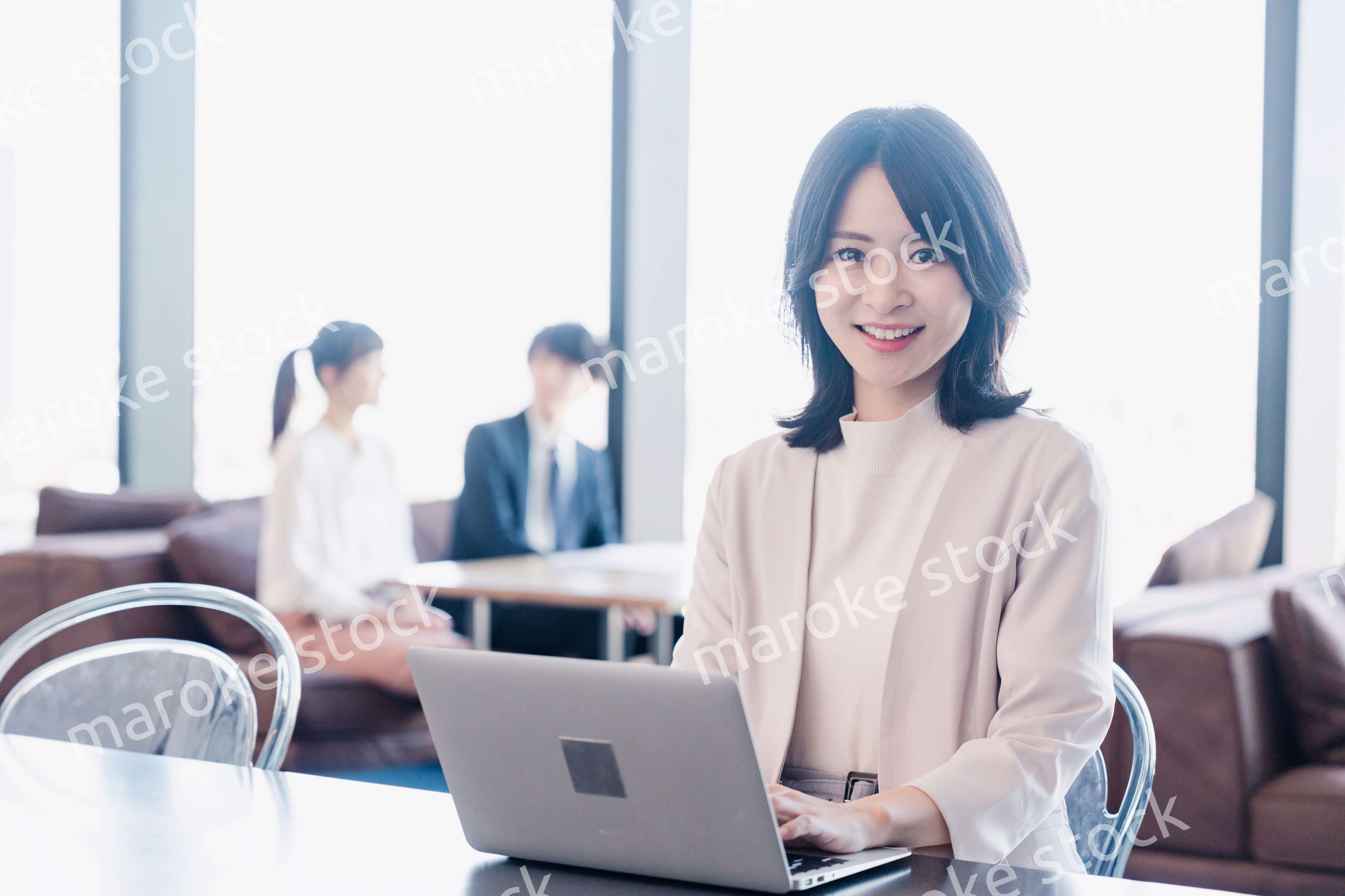シェアオフィスでノートパソコンを使うビジネスウーマン
