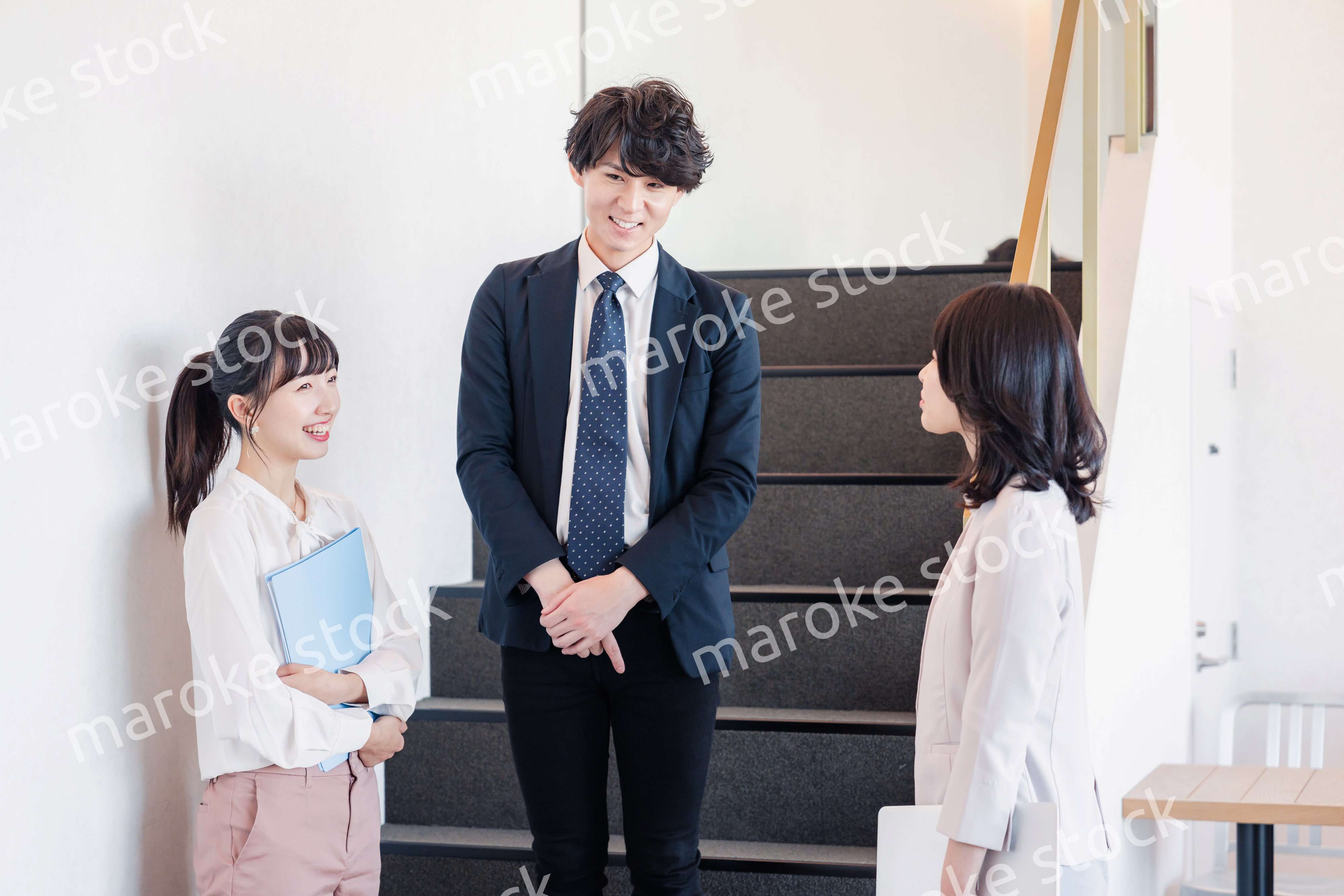 オフィスで仲良く話す若いビジネスパーソン