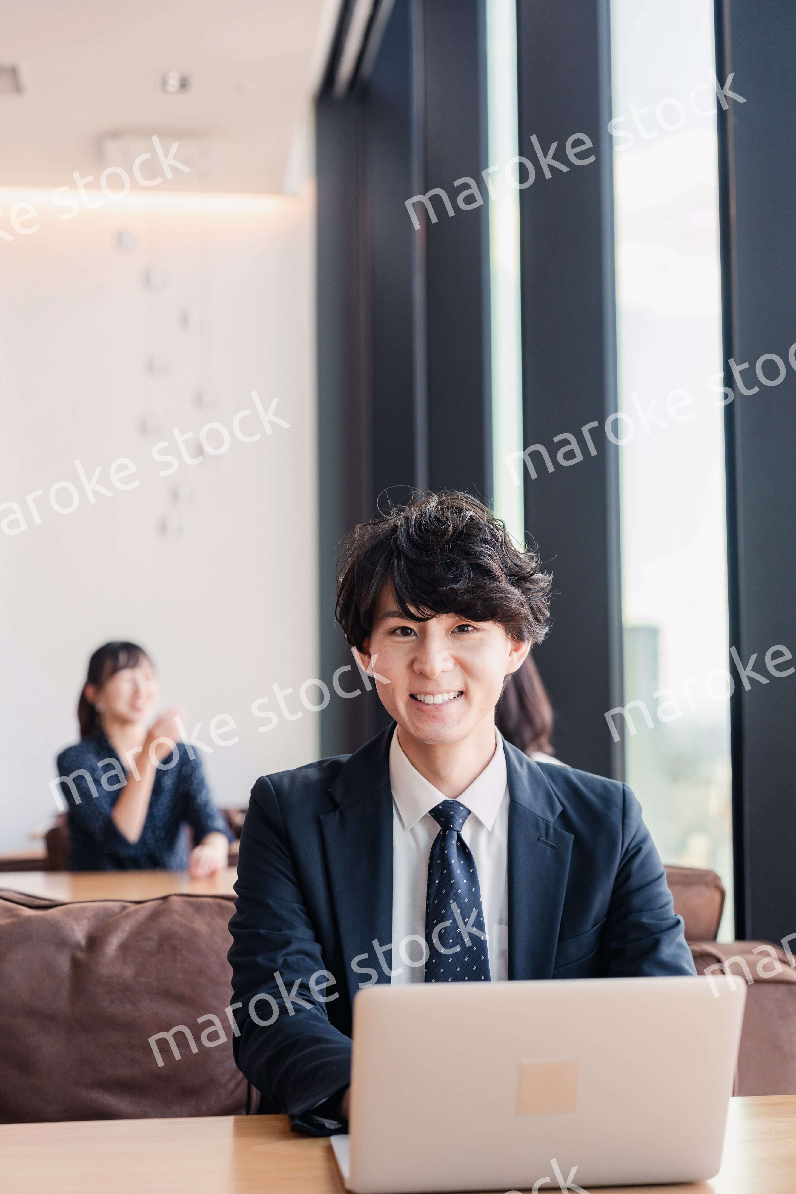 オフィスで笑顔で働くビジネスマン
