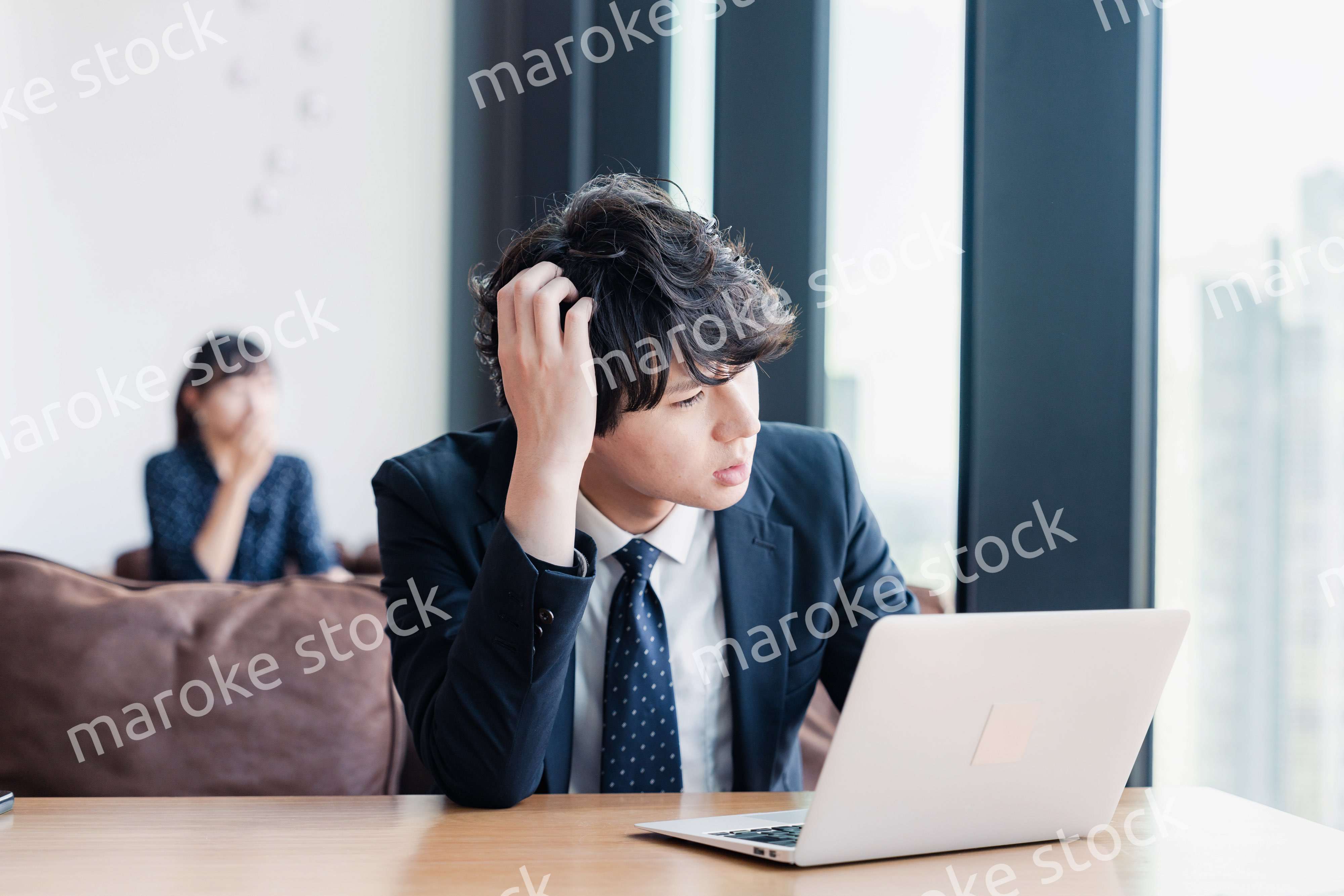 オフィスで頭を抱えるビジネスマン