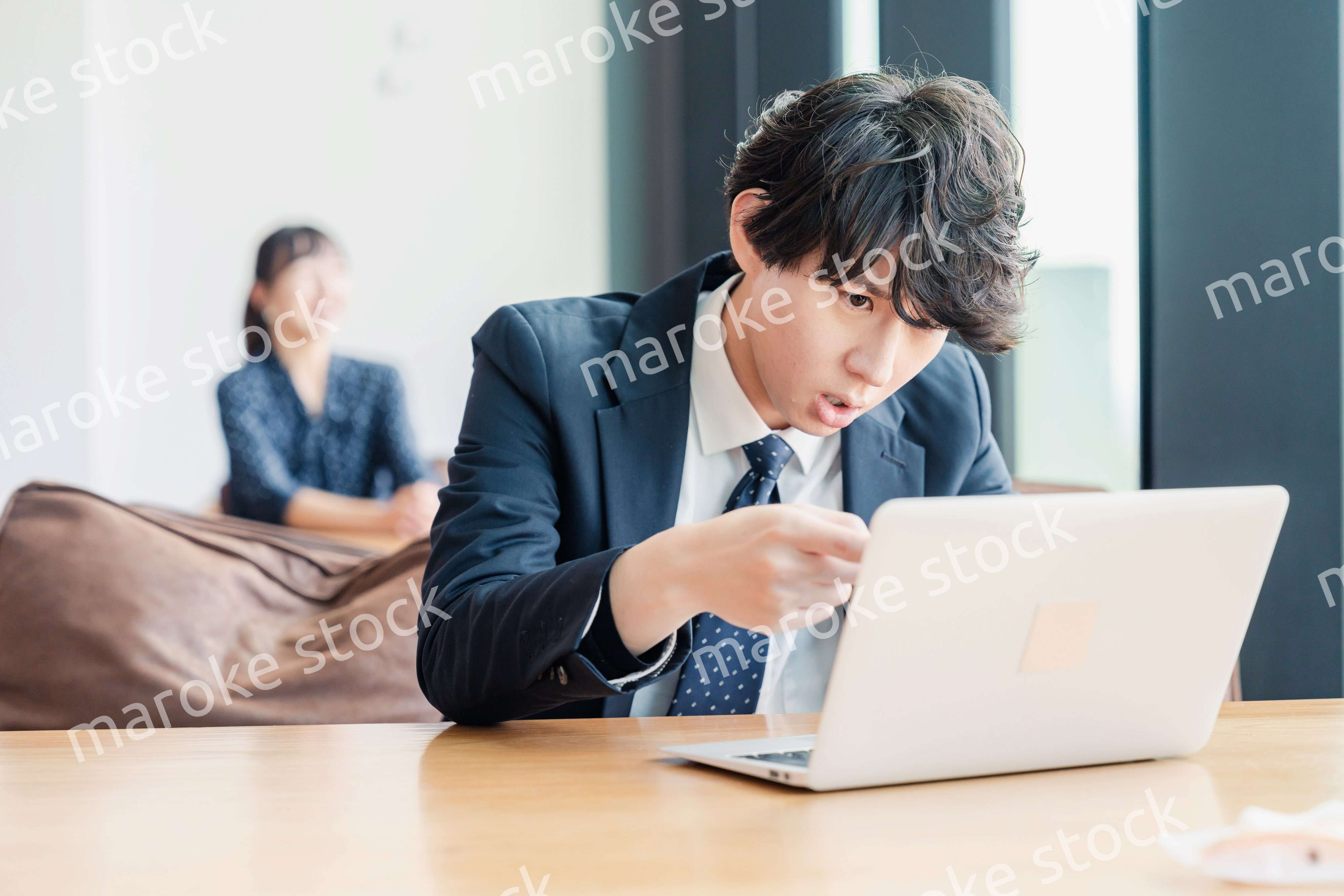 オフィスでパソコンと格闘するビジネスマン