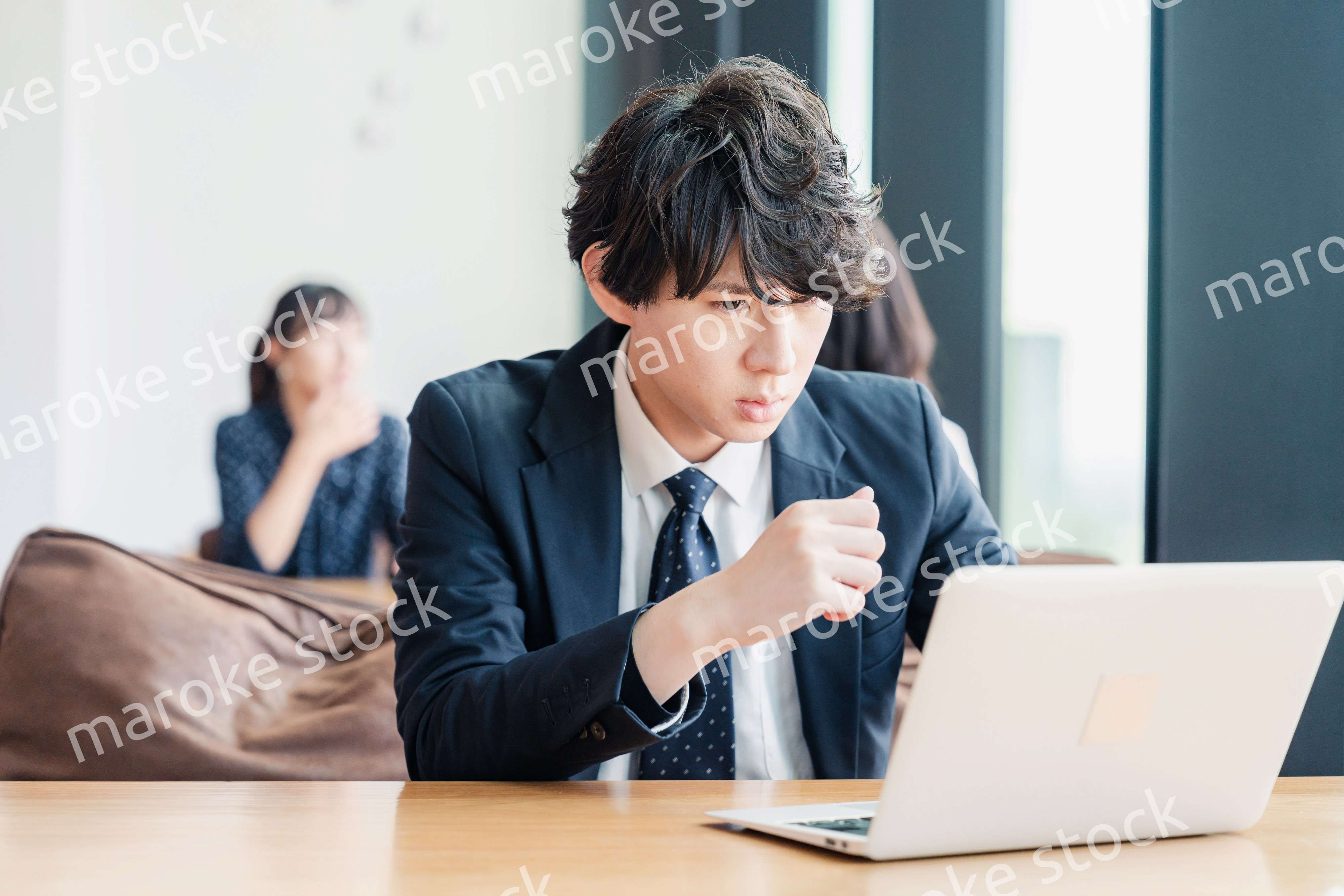 オフィスでパソコンと格闘するビジネスマン