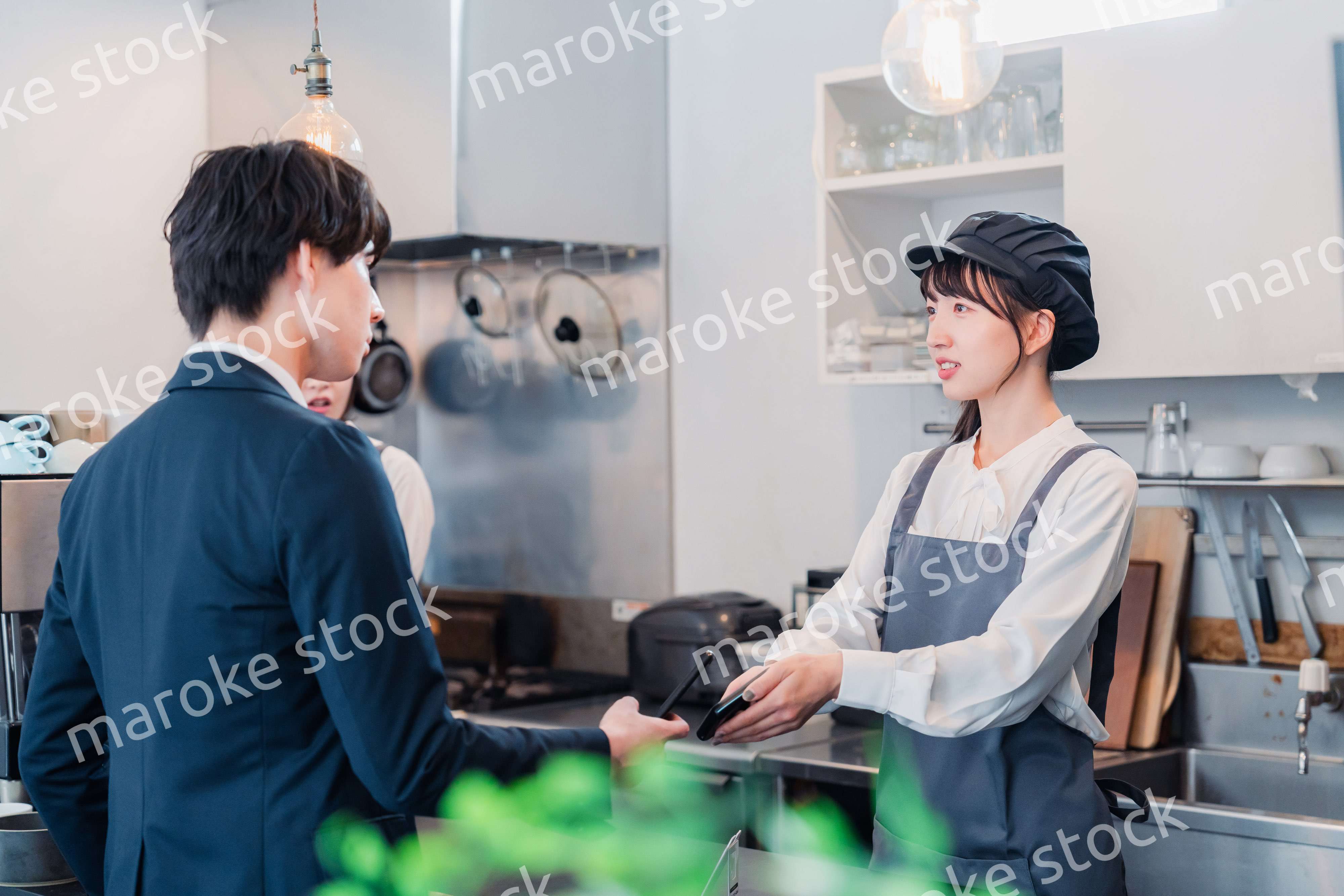 スマホでタッチ決済をする男性