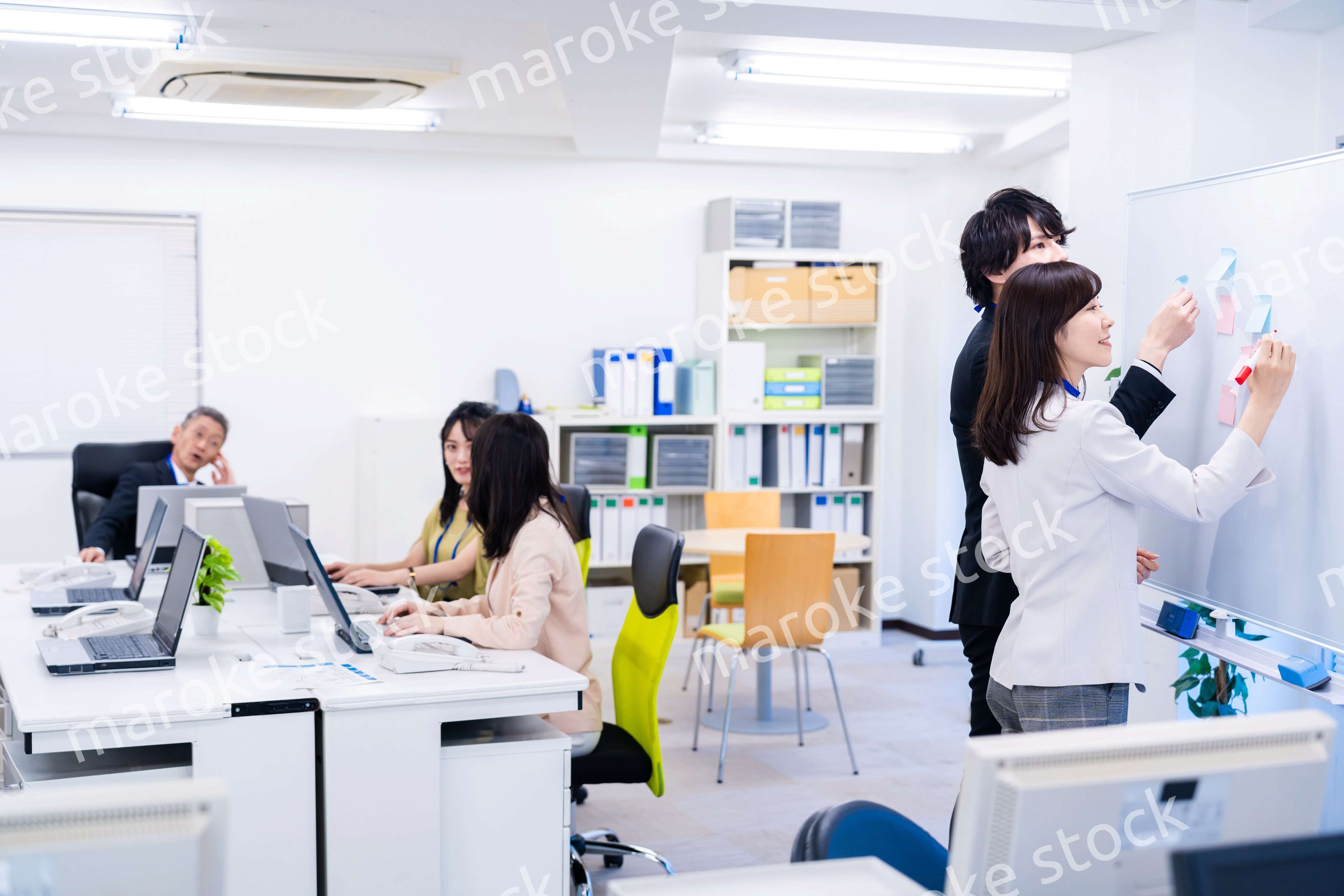 楽しくオフィスで仕事をするスタッフ