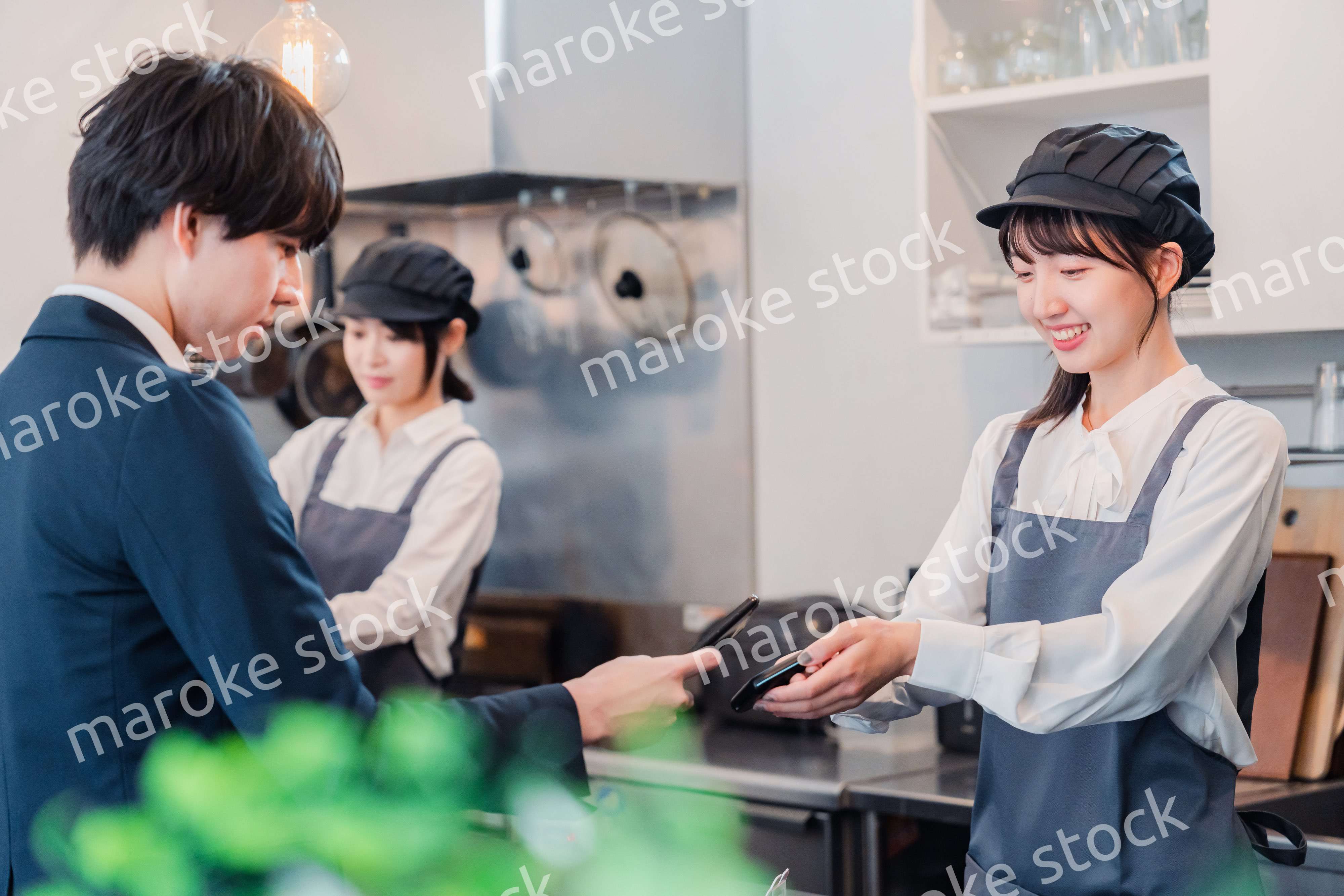 スマホでタッチ決済をする男性