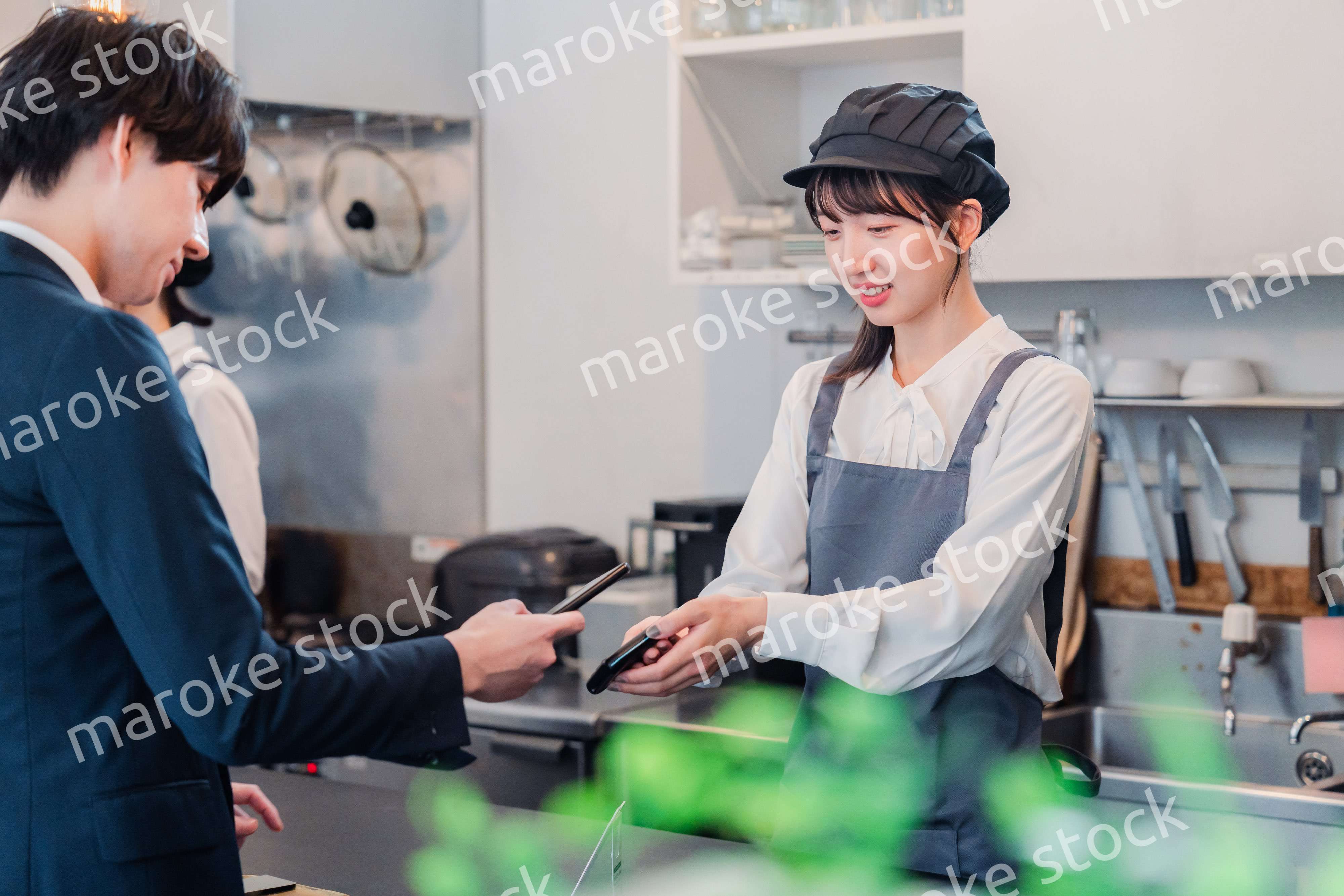 スマホでタッチ決済をする男性