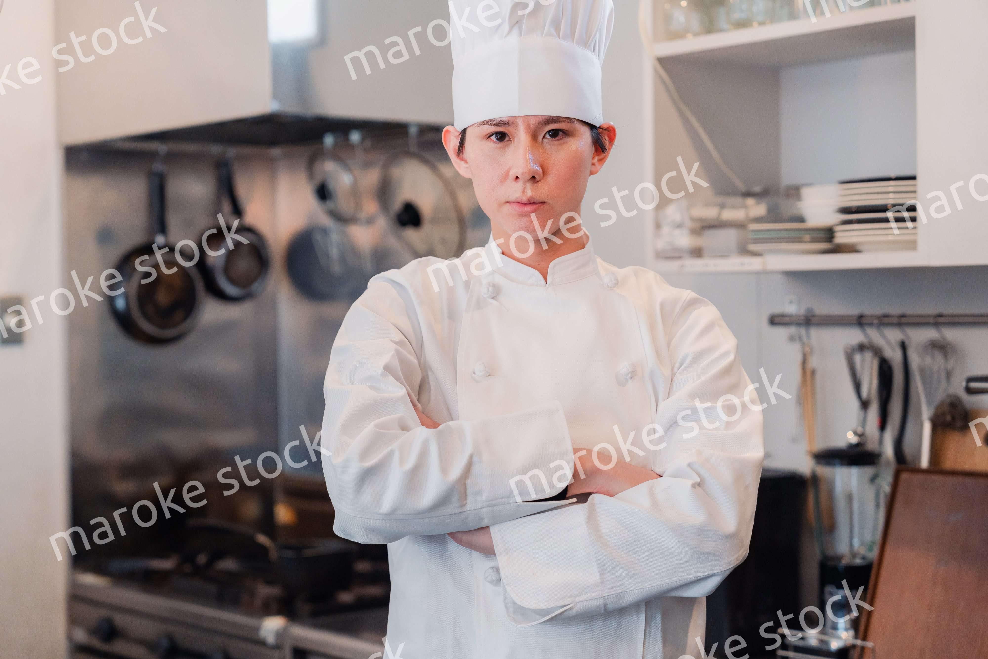 真剣な表情で腕組をする料理人