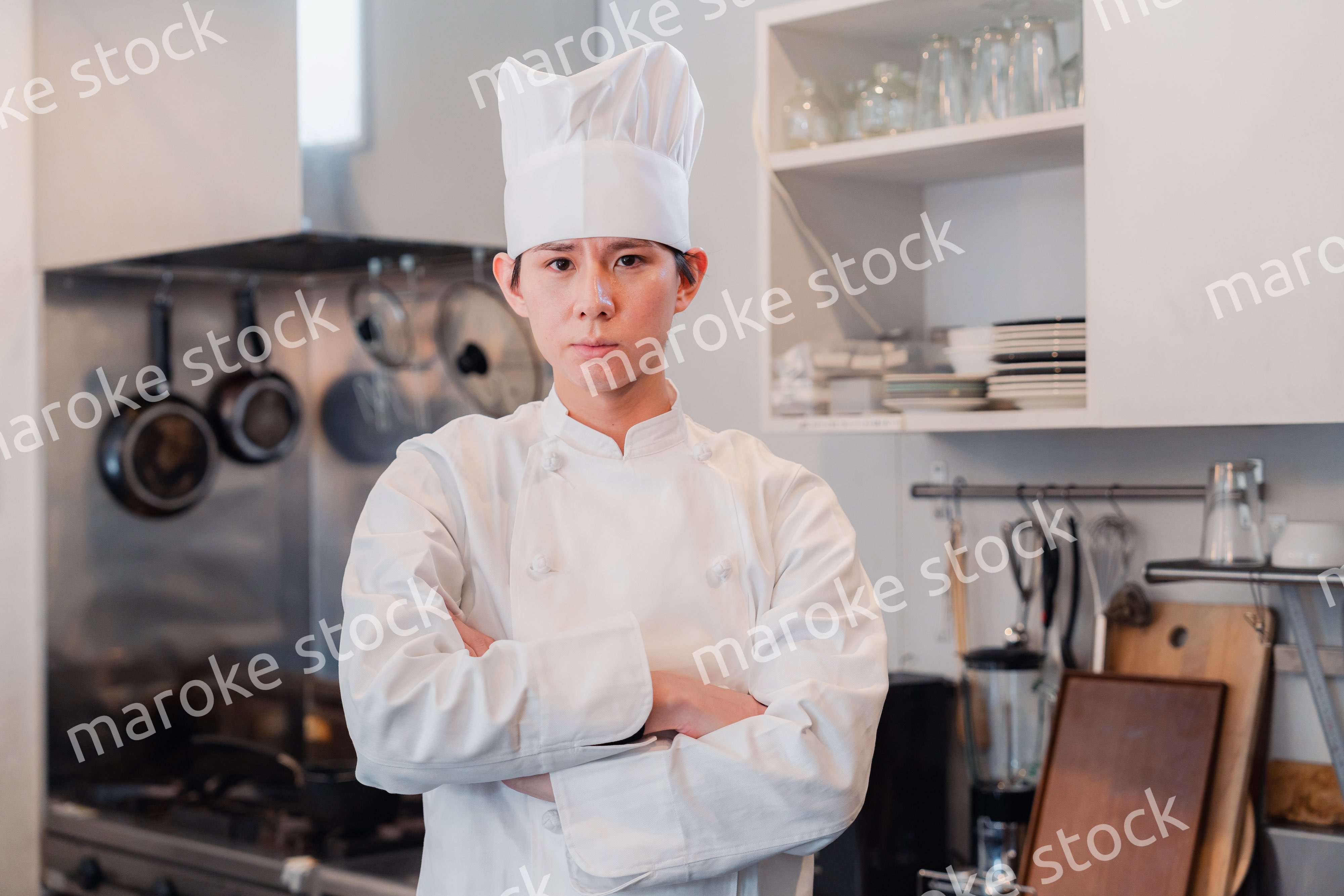 真剣な表情で腕組をする料理人