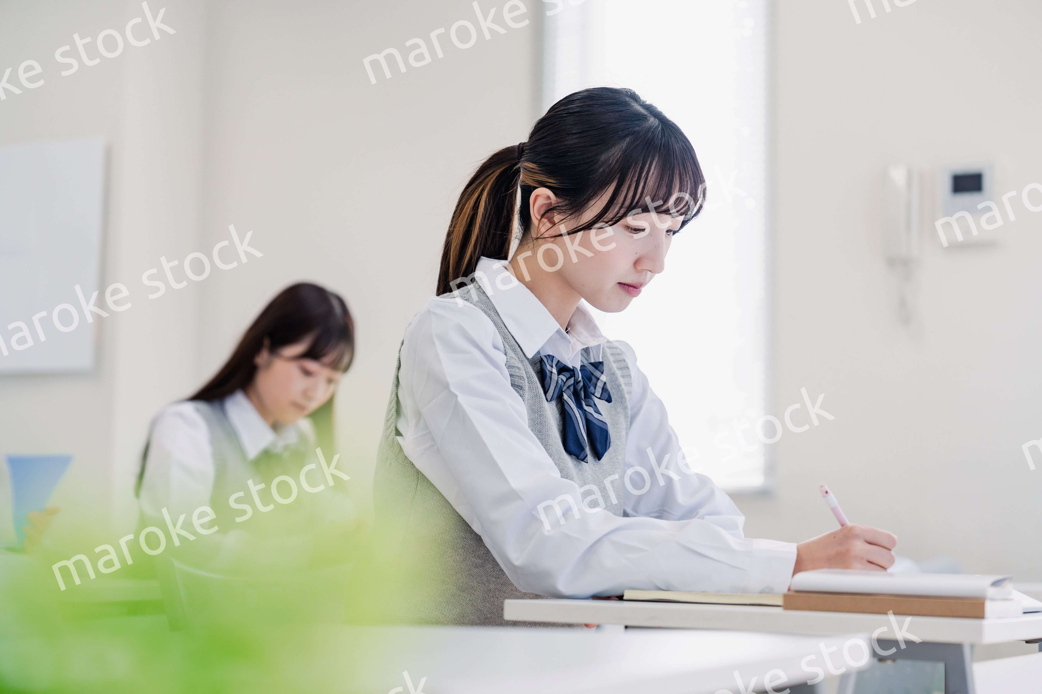 集中してノートを取る高校生