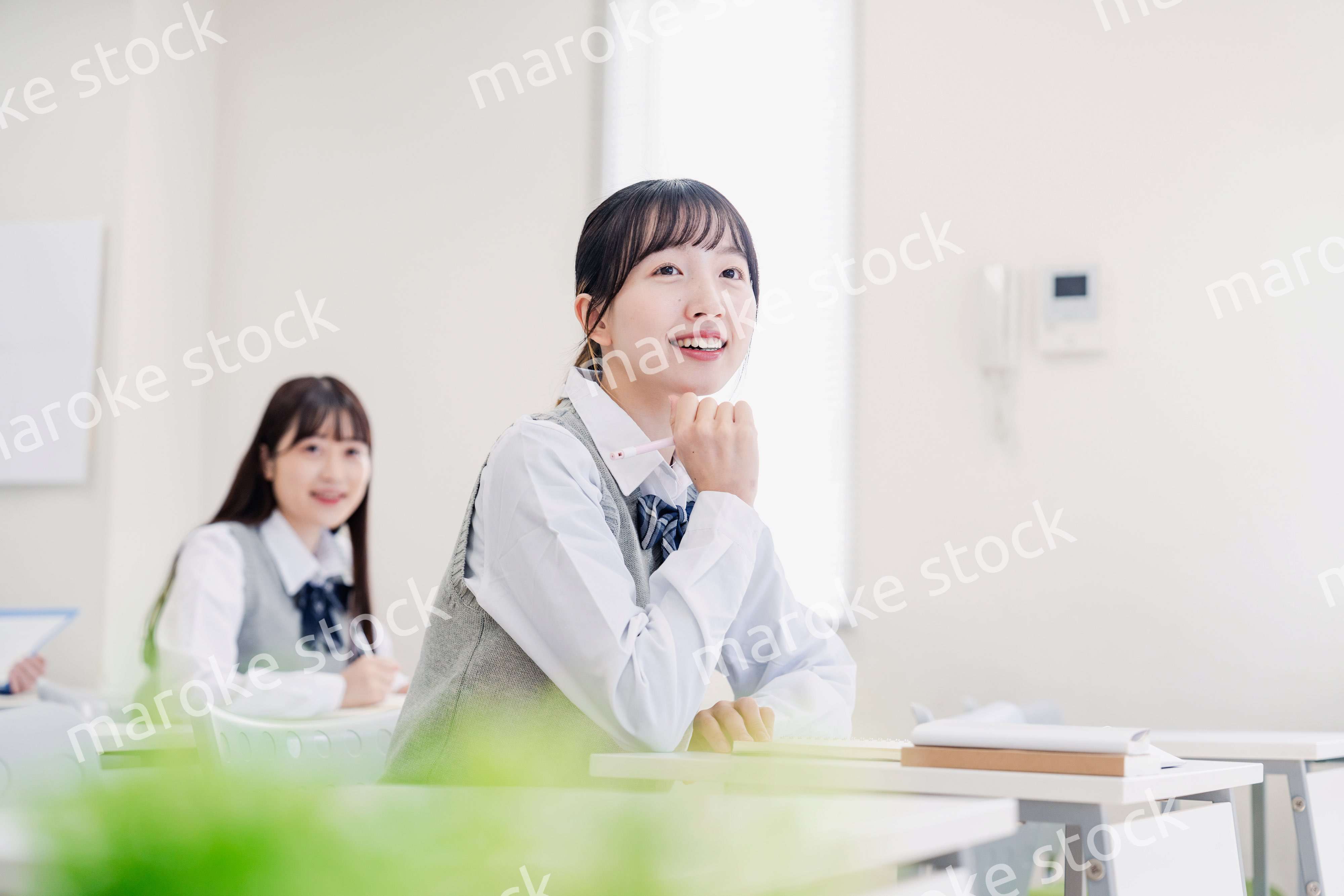 教室でにこやかに授業を受ける女子高生