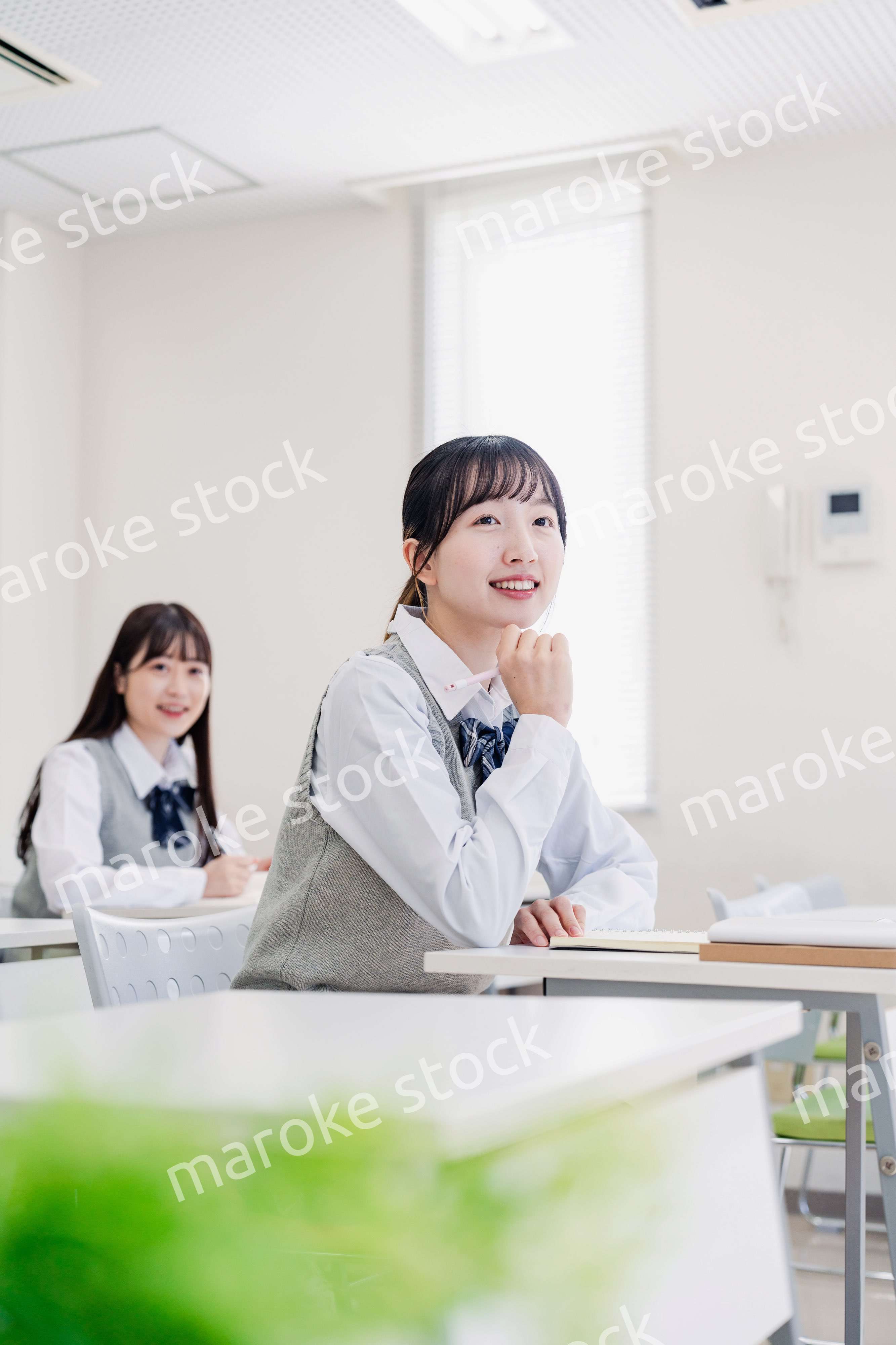 教室でにこやかに授業を受ける女子高生