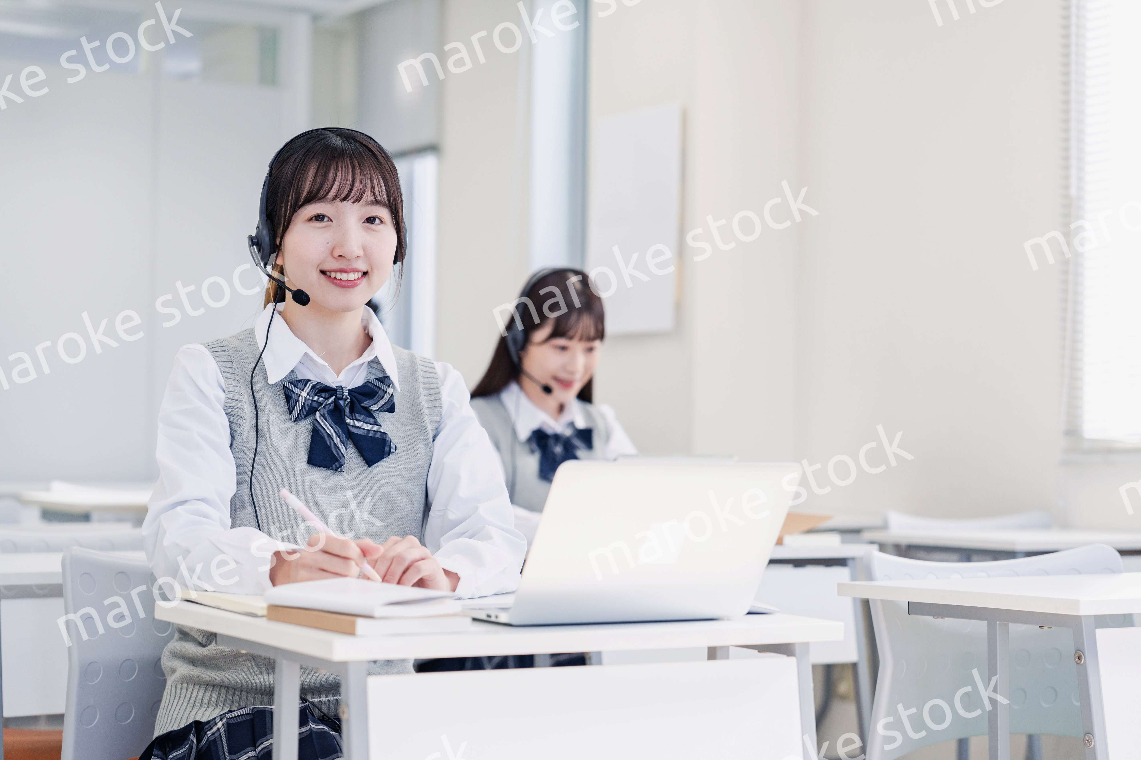 教室でノートパソコンを使う女子高生