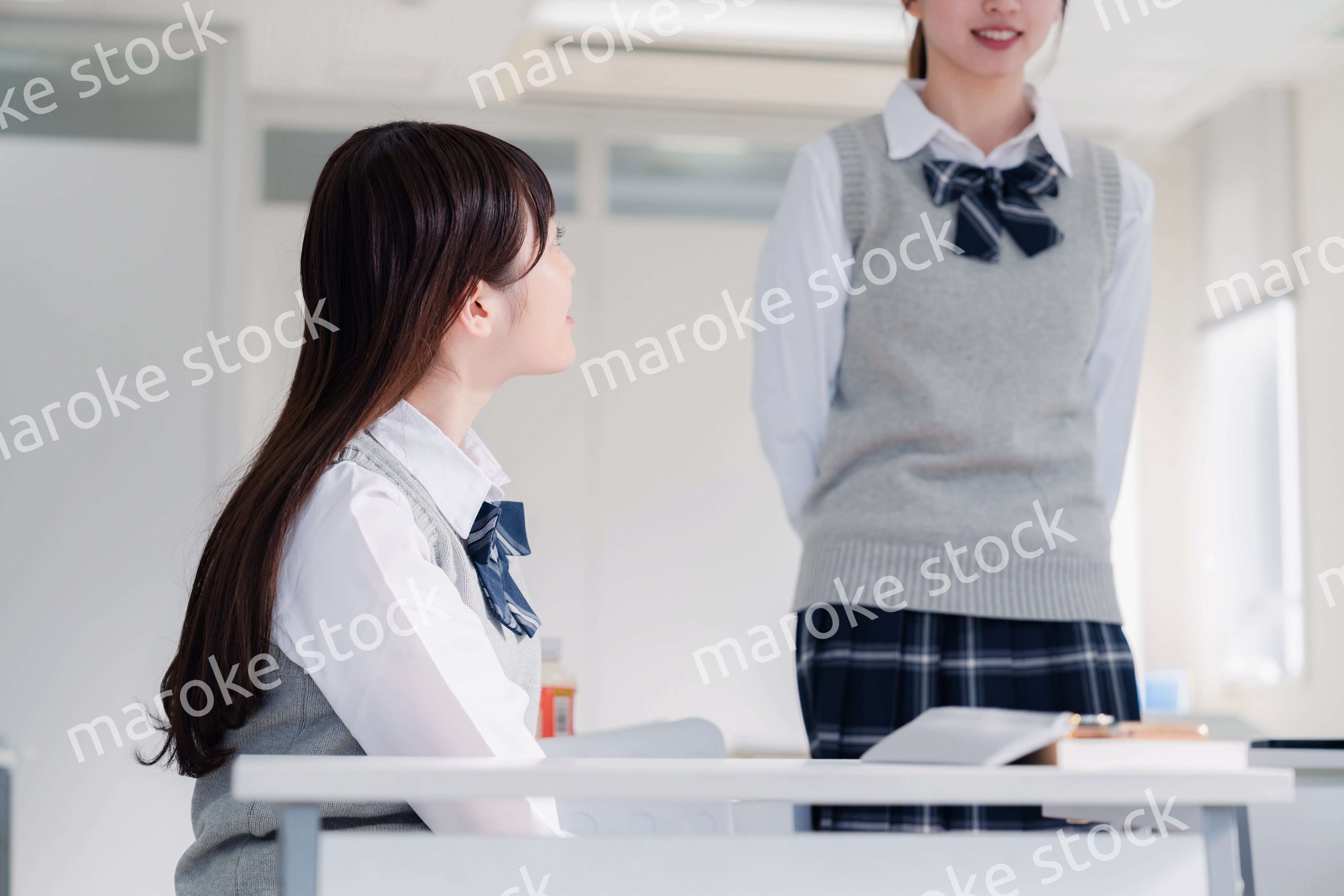 教室で休み時間に話す女子高生