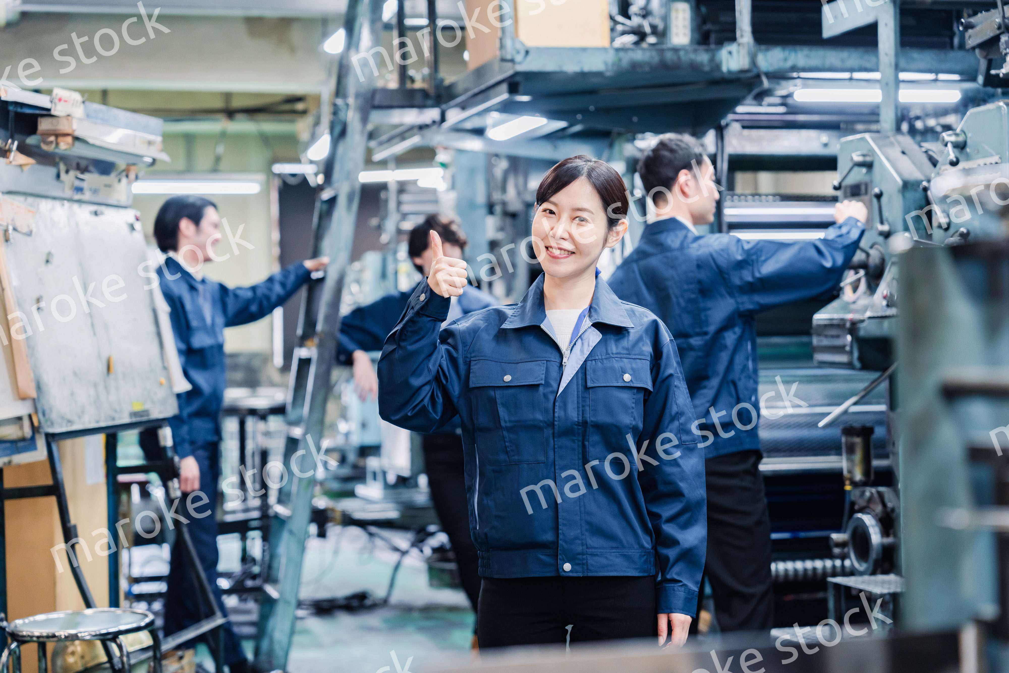 グッドサインをする工場労働者