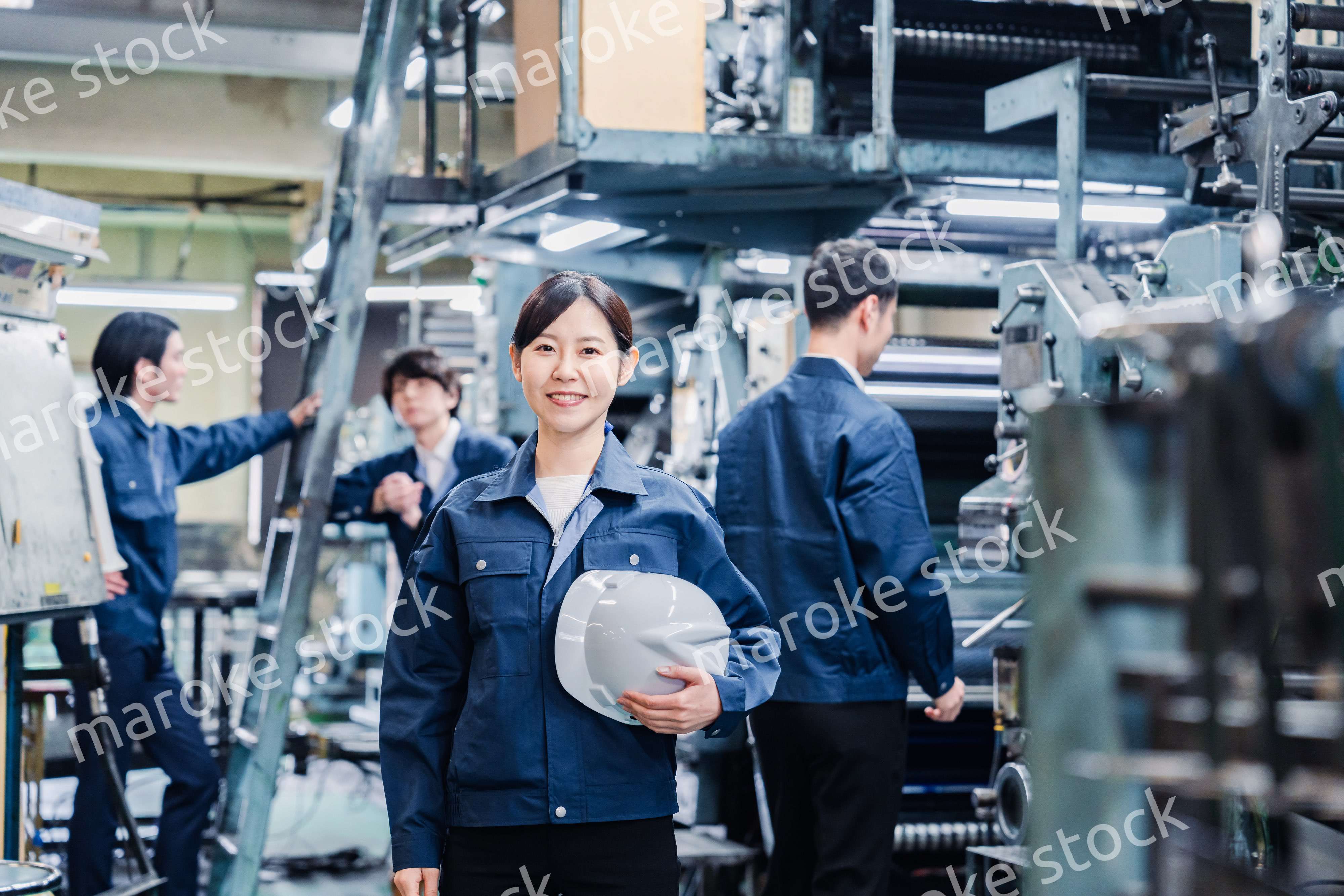 ヘルメットを持つ女性作業員