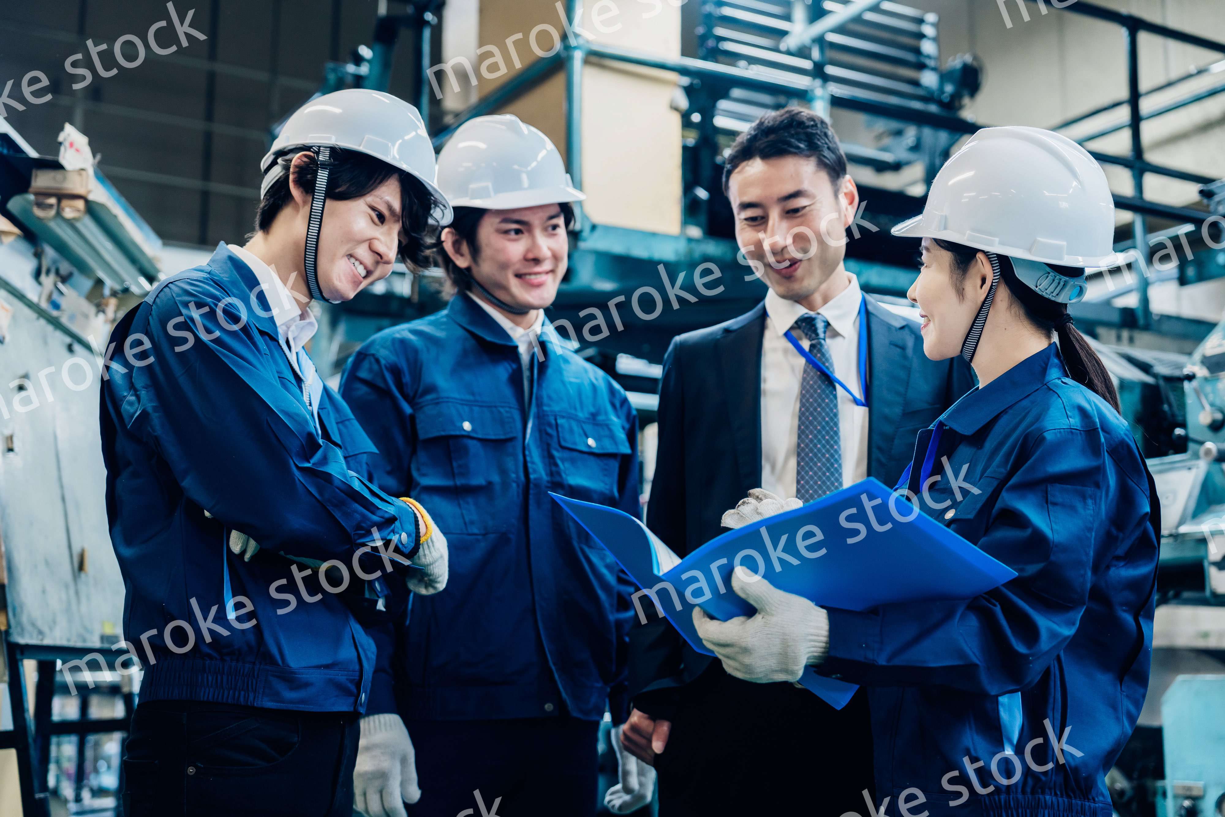 工場で資料を確認する労働者