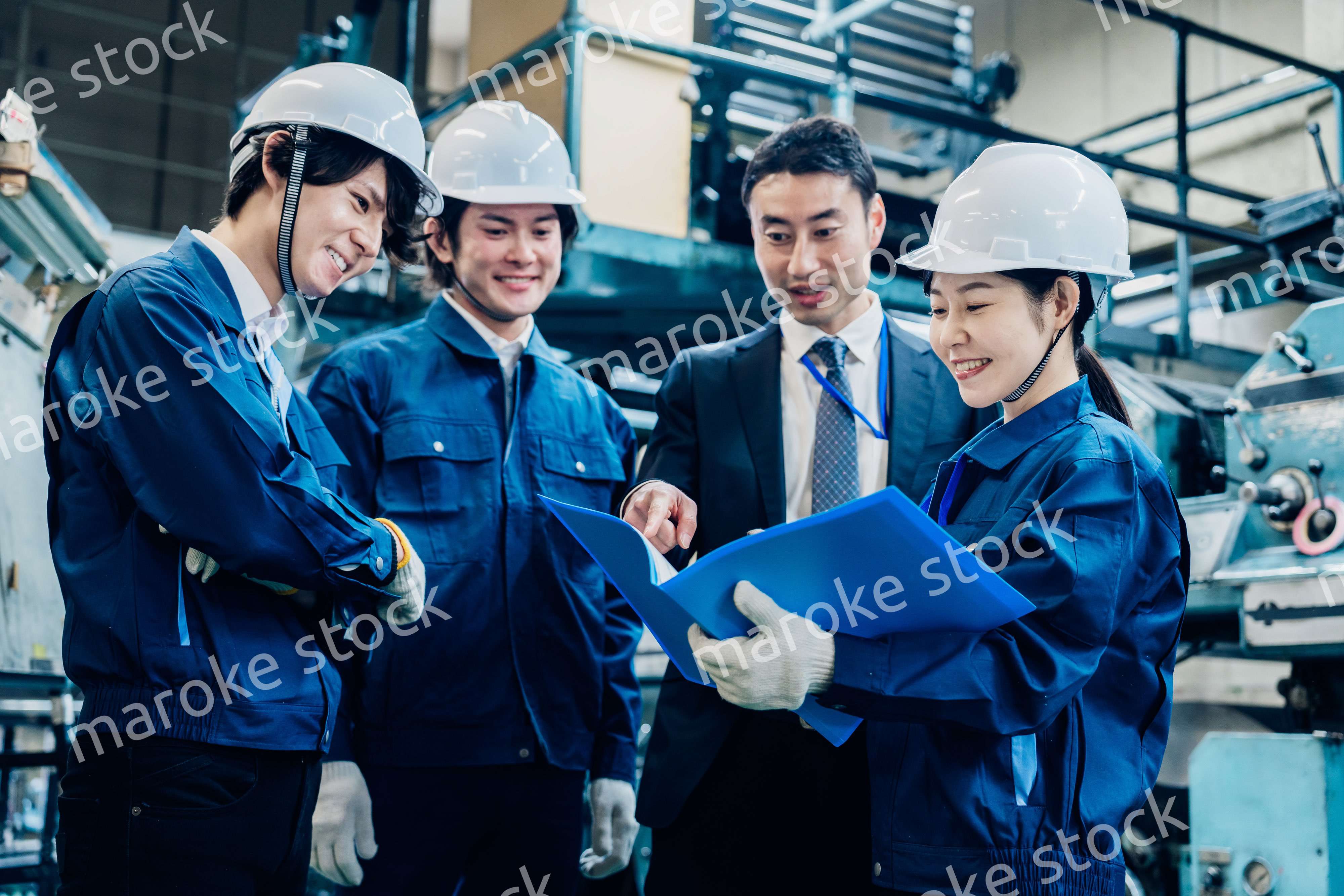 工場で資料を確認する労働者