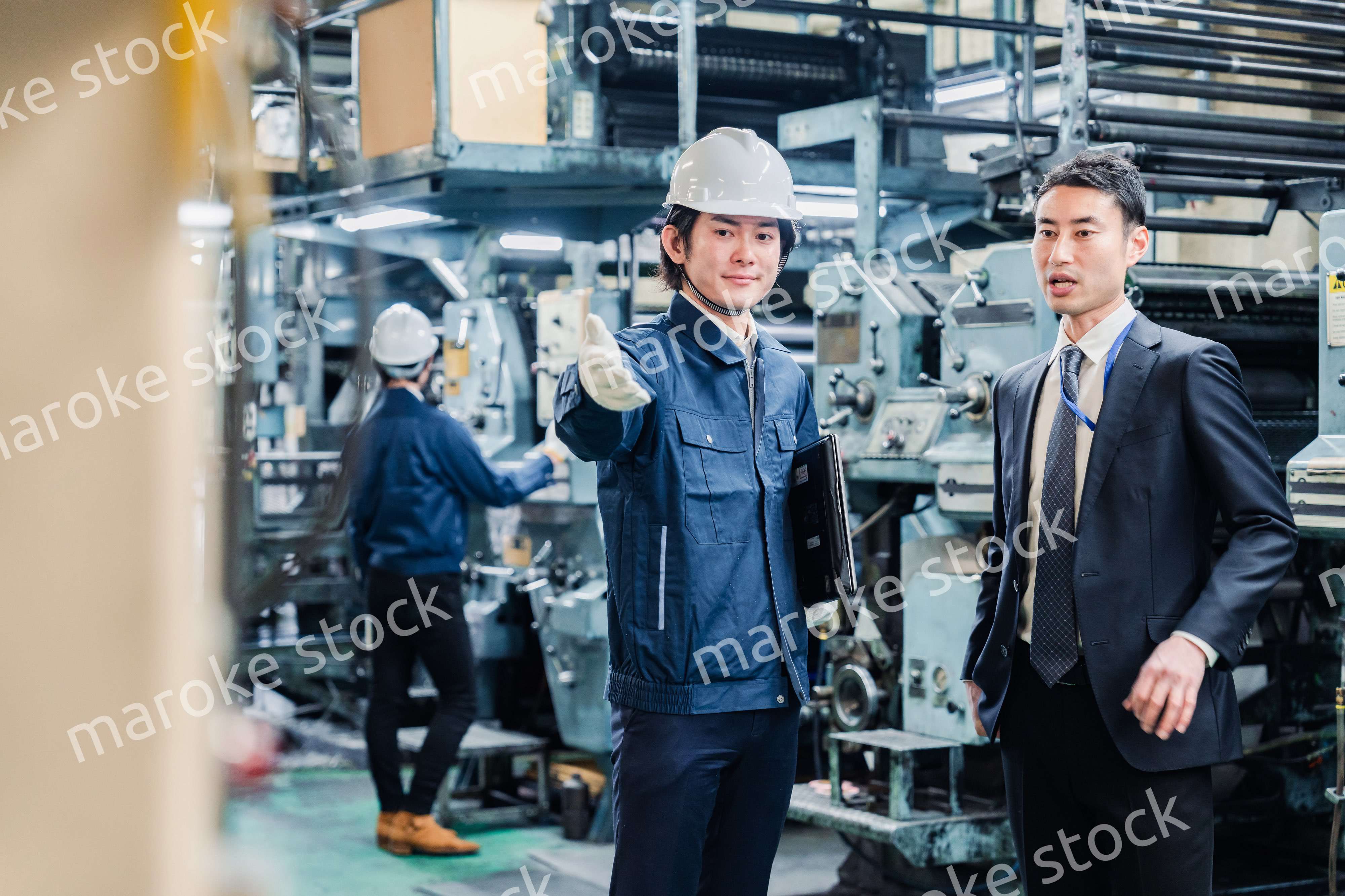 工場を視察するビジネスマン