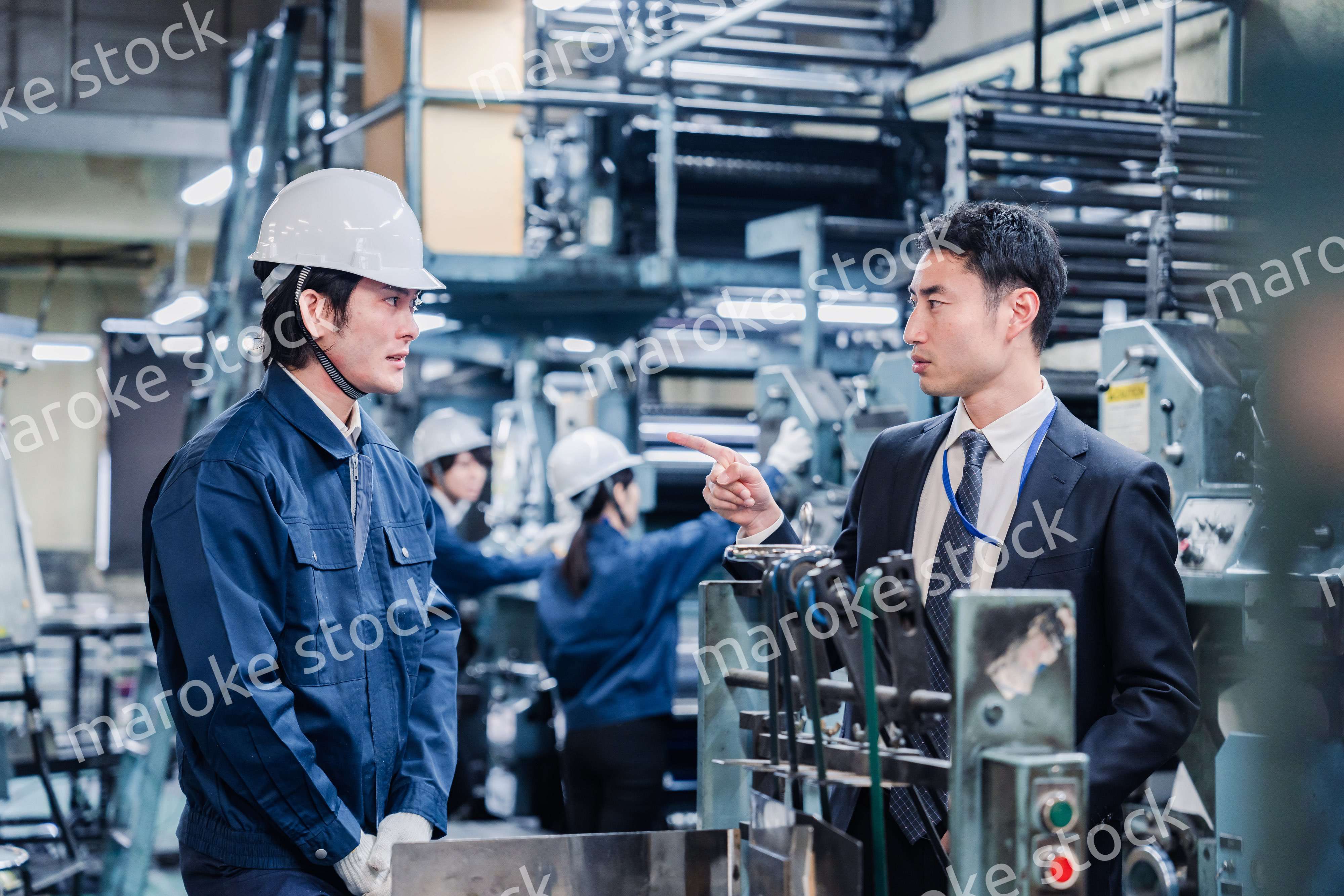 工場の作業員に注意をする経営者