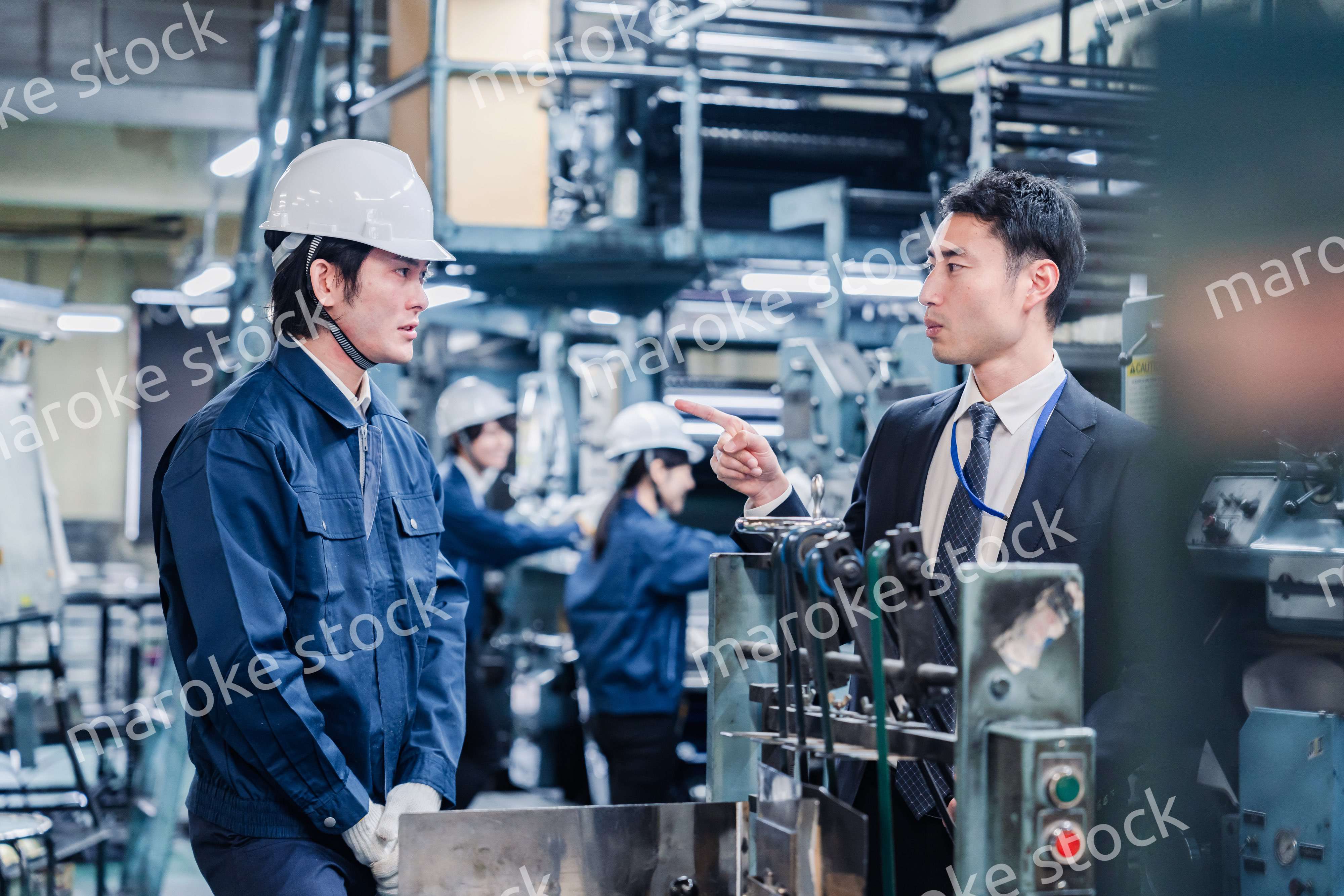 工場の作業員に注意をする経営者