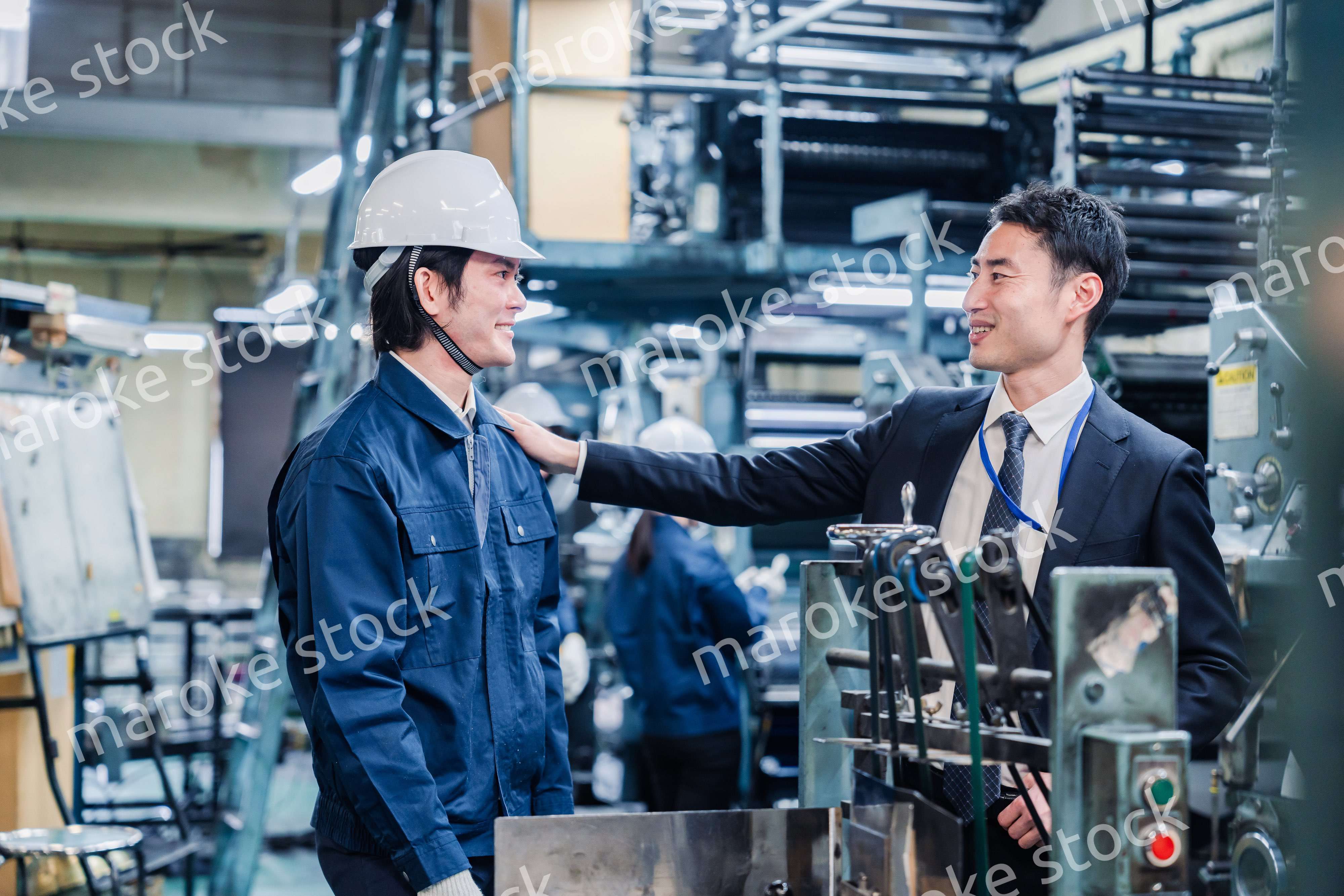 現場スタッフの肩を叩くオーナー