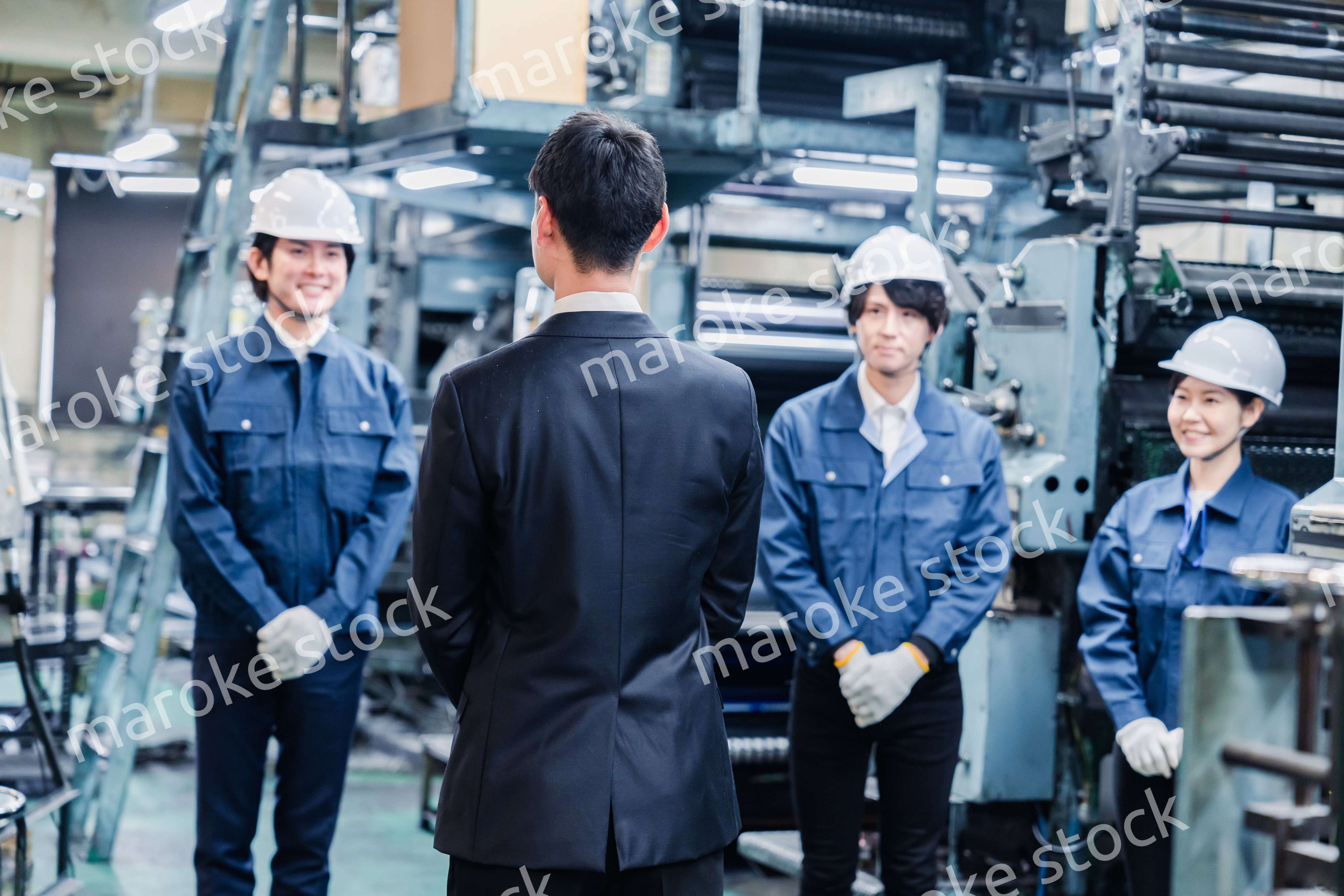 管理職の訓示を聴く工場スタッフ