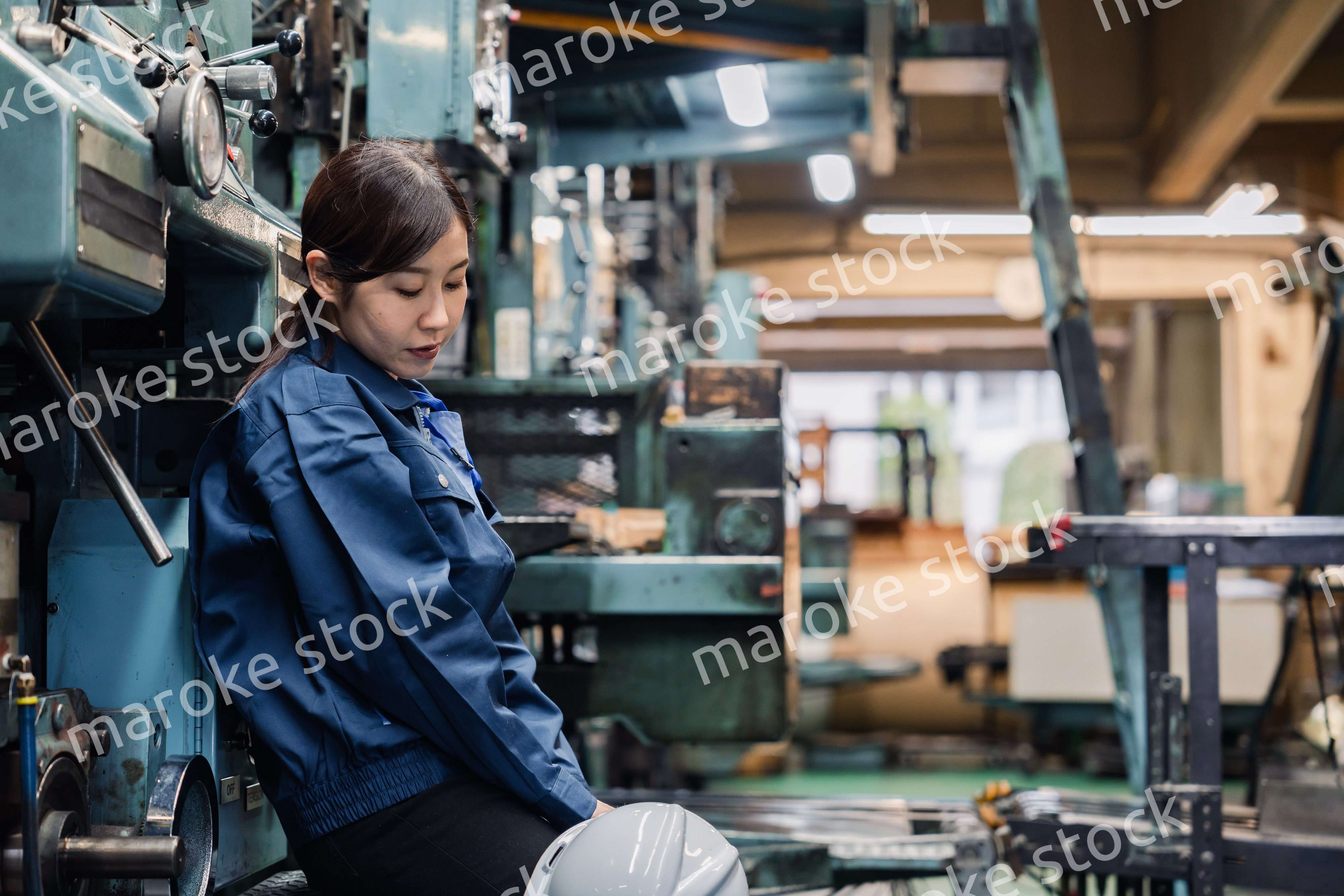 過労でやる気をなくす工場労働者の女性