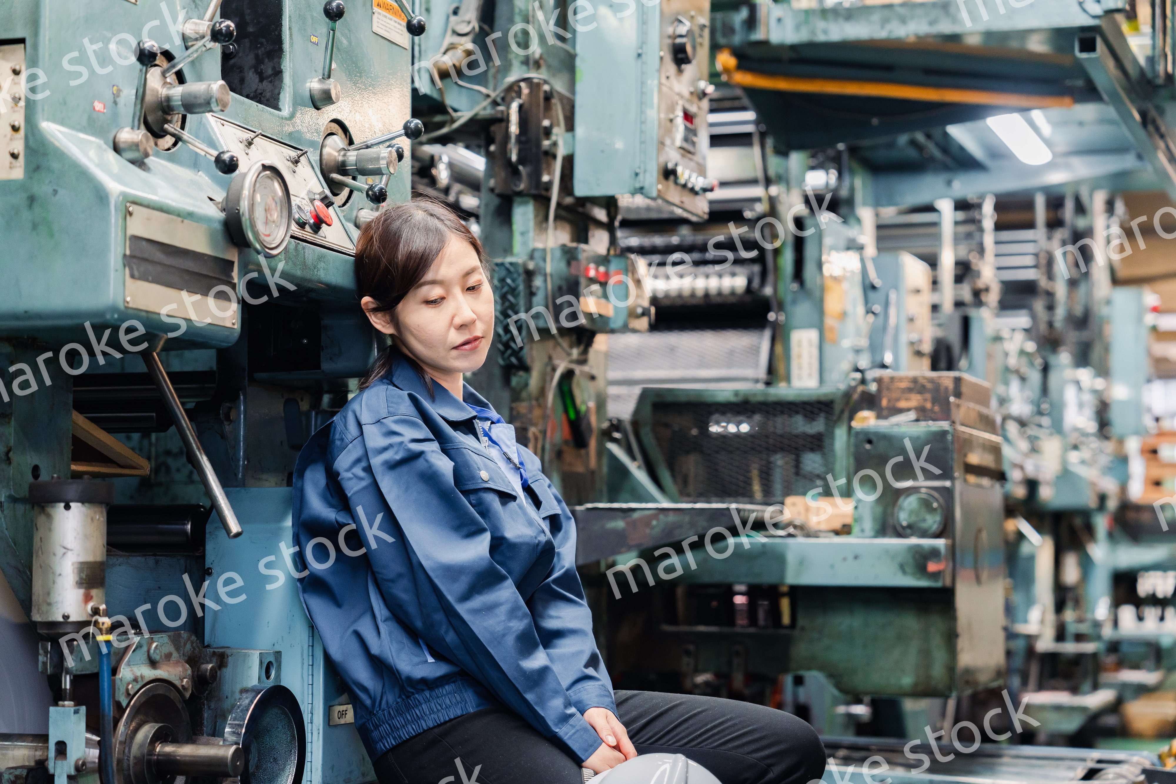 過労でやる気をなくす工場労働者の女性