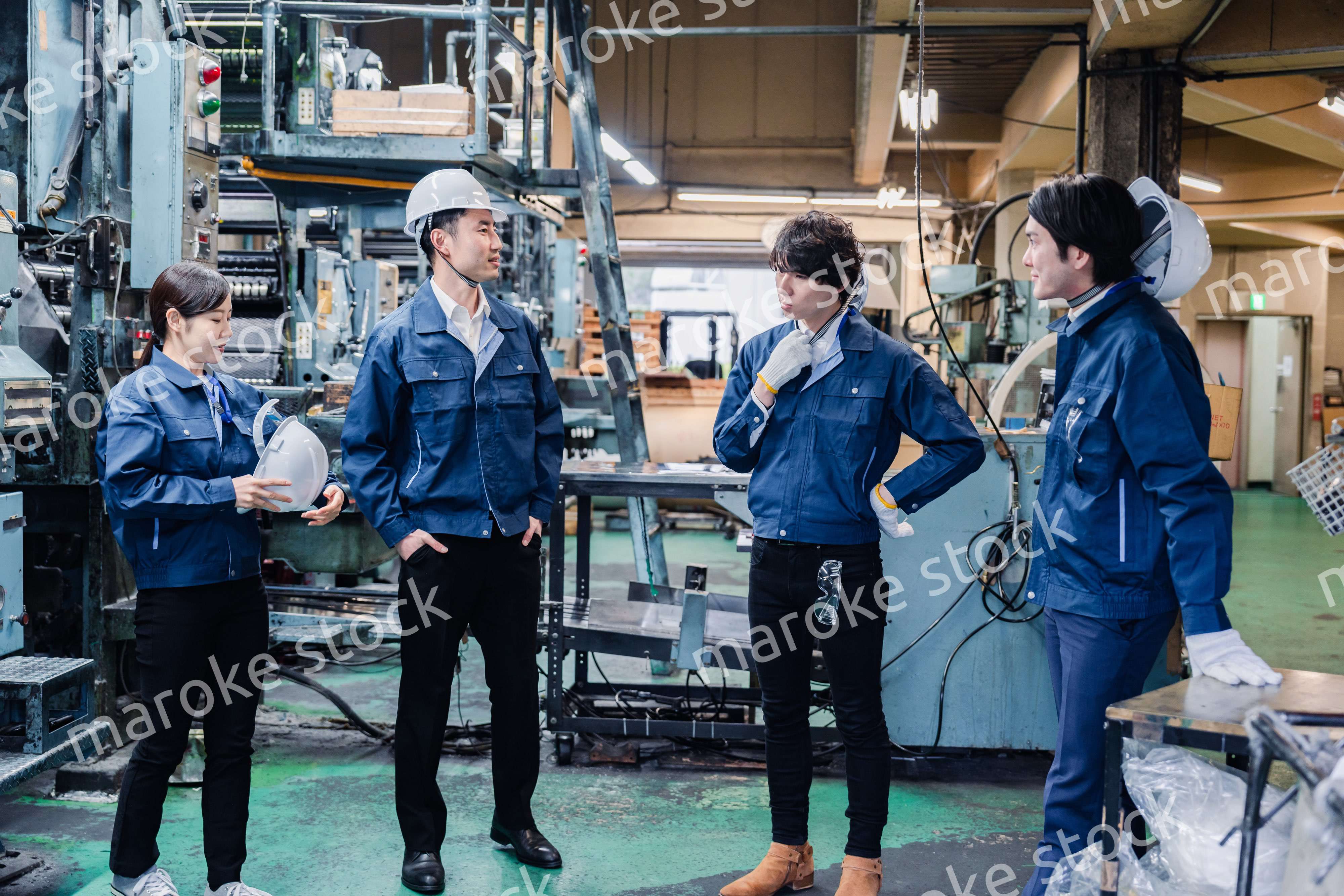 休憩時間に仲良く雑談をする工場労働者