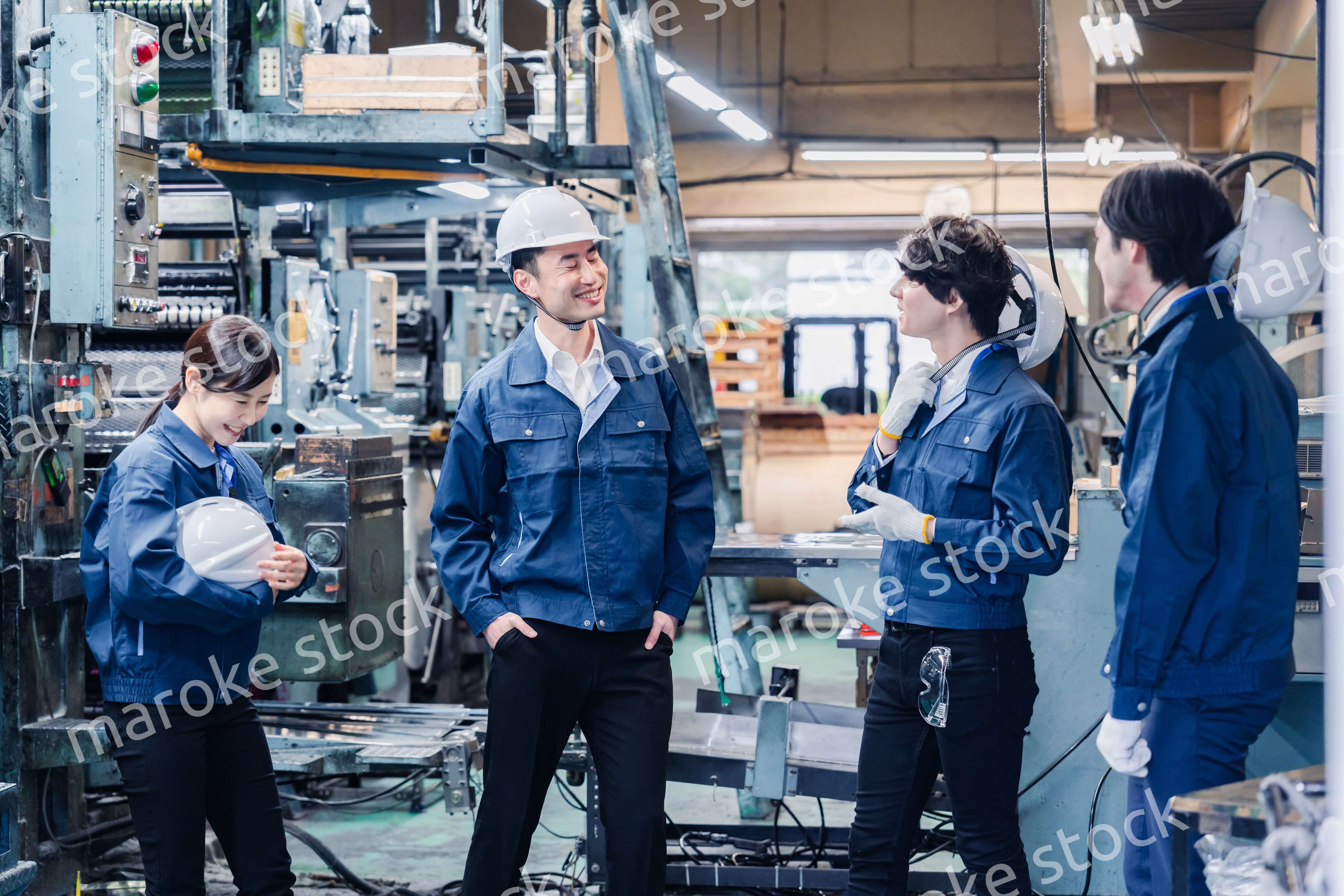 休憩時間に仲良く雑談をする工場労働者