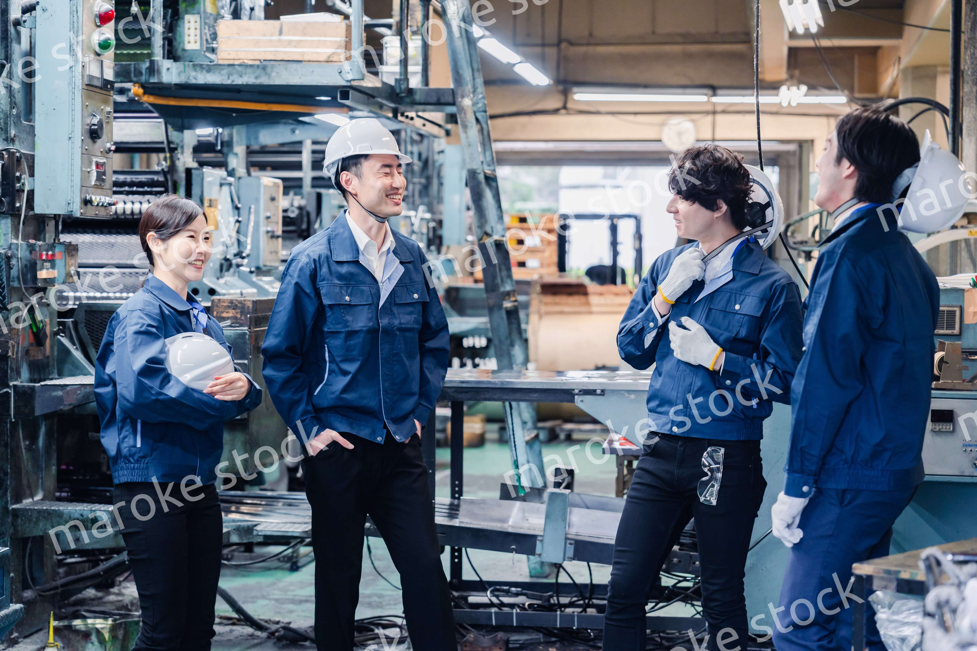 休憩時間に仲良く雑談をする工場労働者