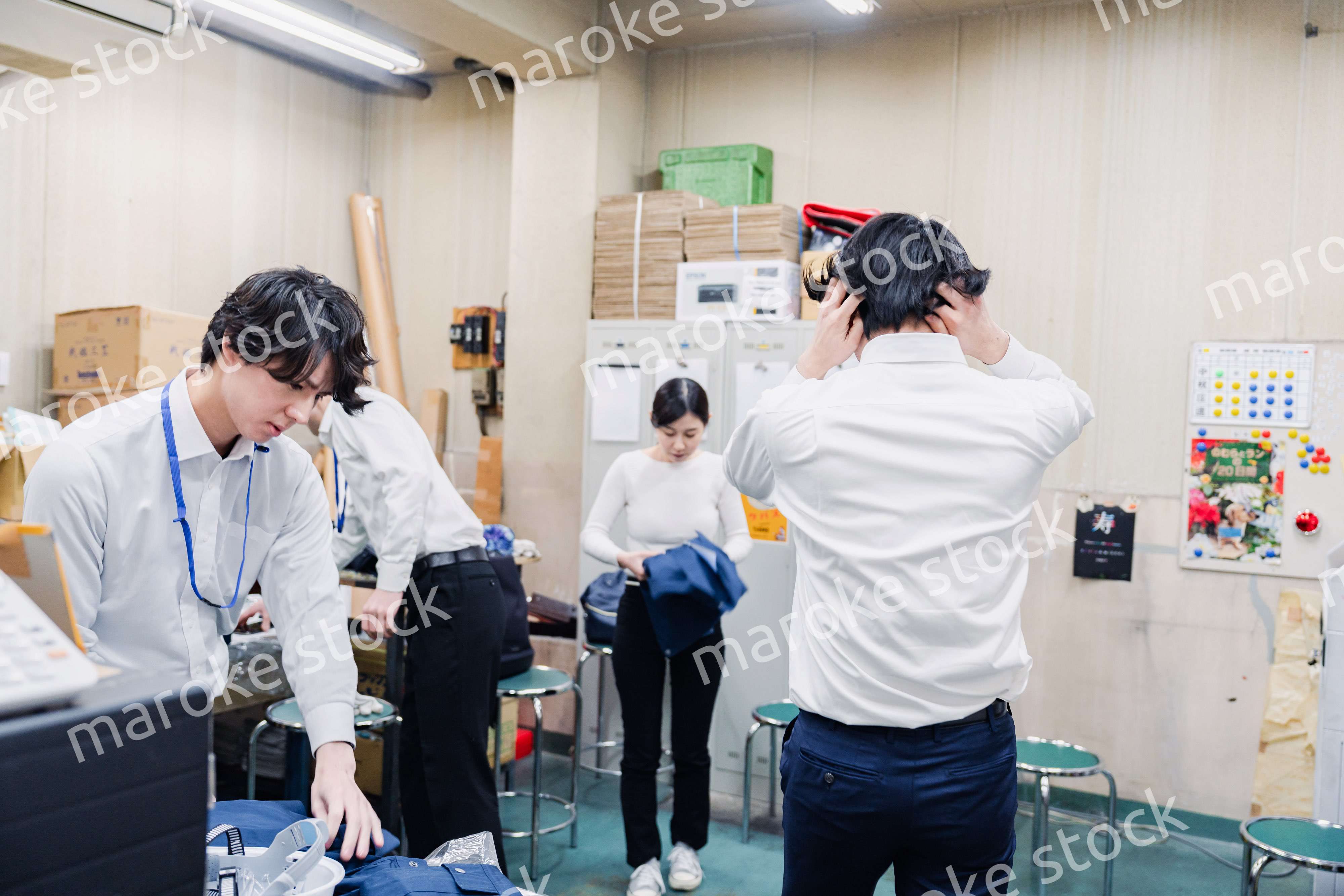 業務終了後にバックヤードで一息をつく従業員