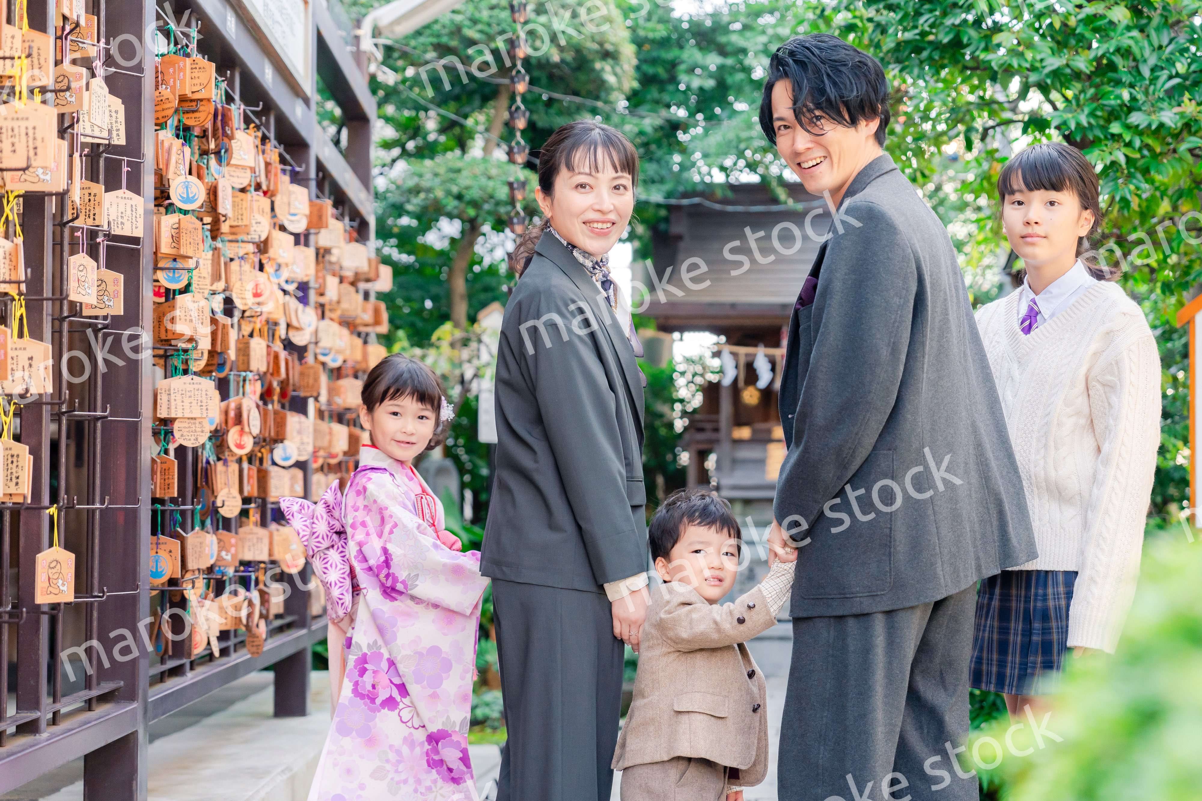 兄弟姉妹揃って神社で七五三のお祝いをする家族