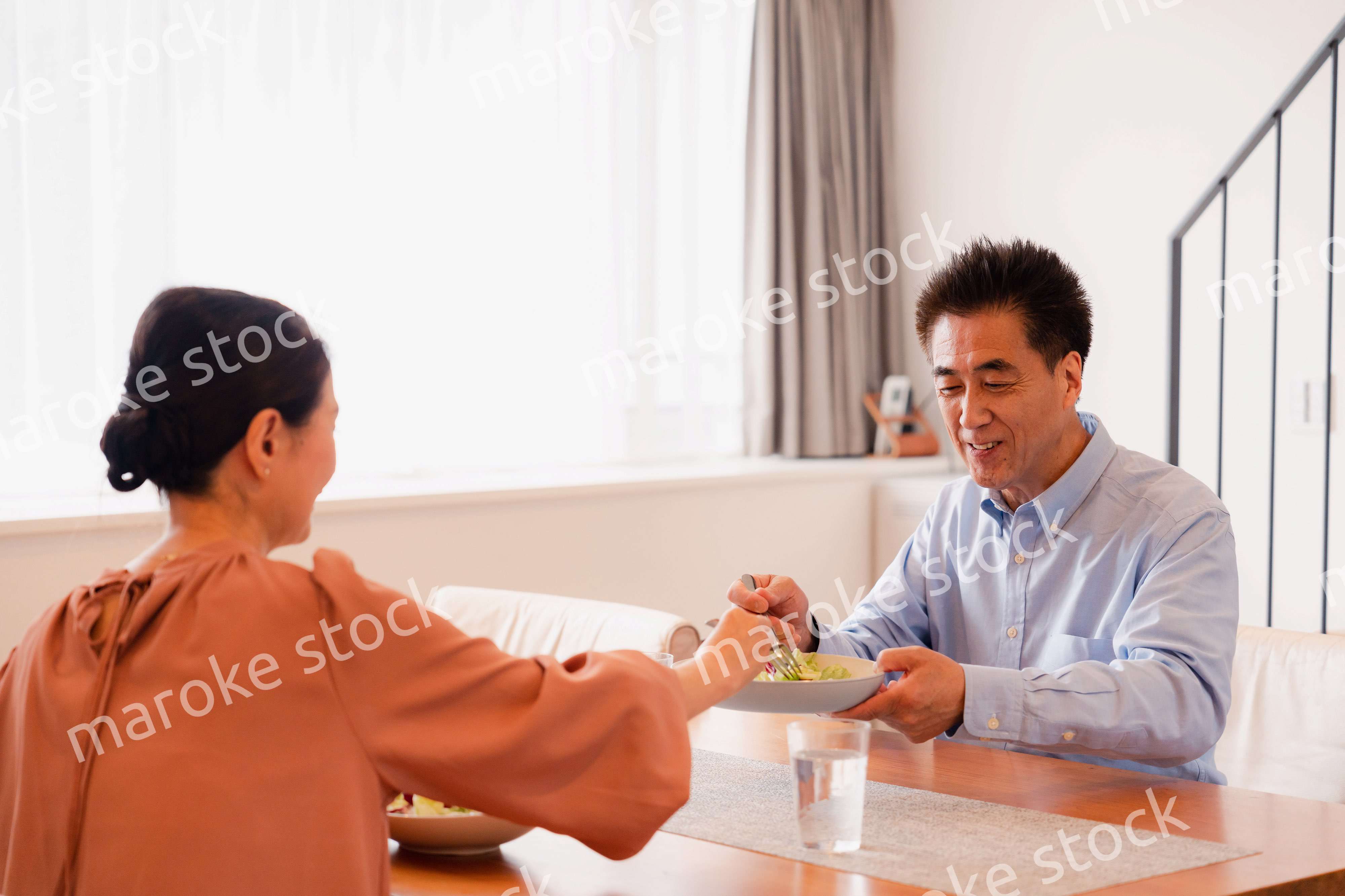 夫婦で食事を楽しむ高齢カップル