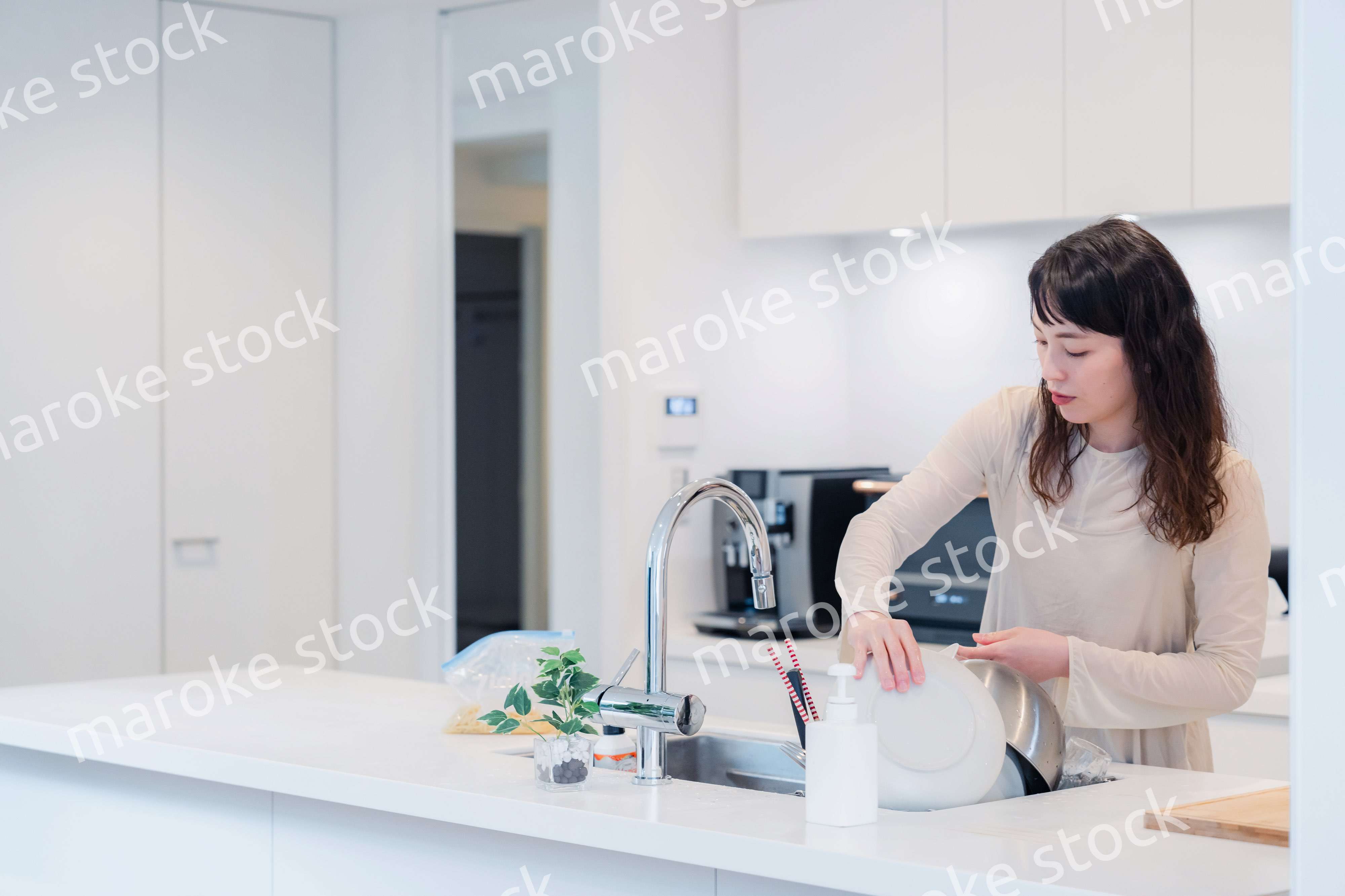 キッチンで忙しく家事をする主婦