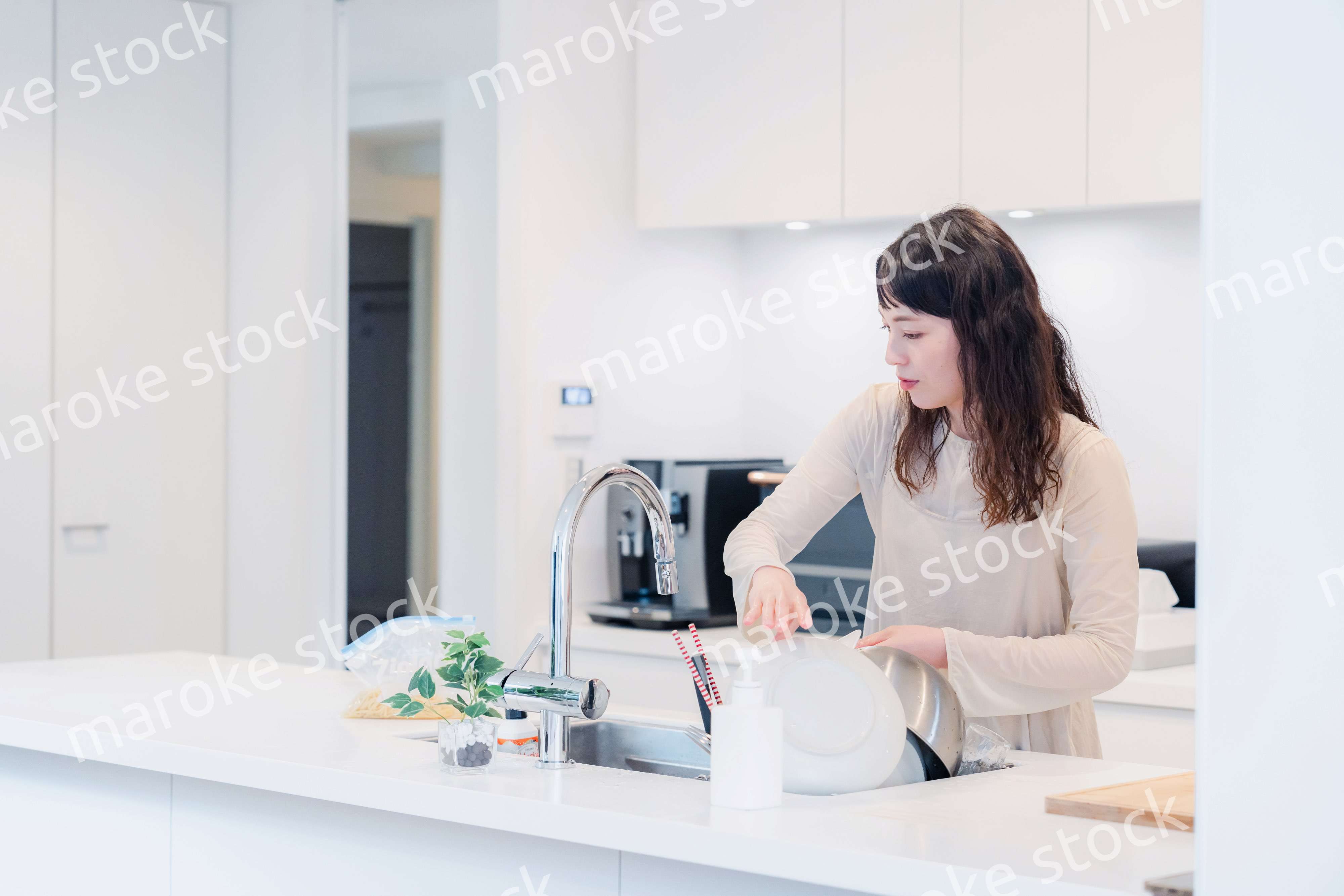 キッチンで忙しく家事をする主婦