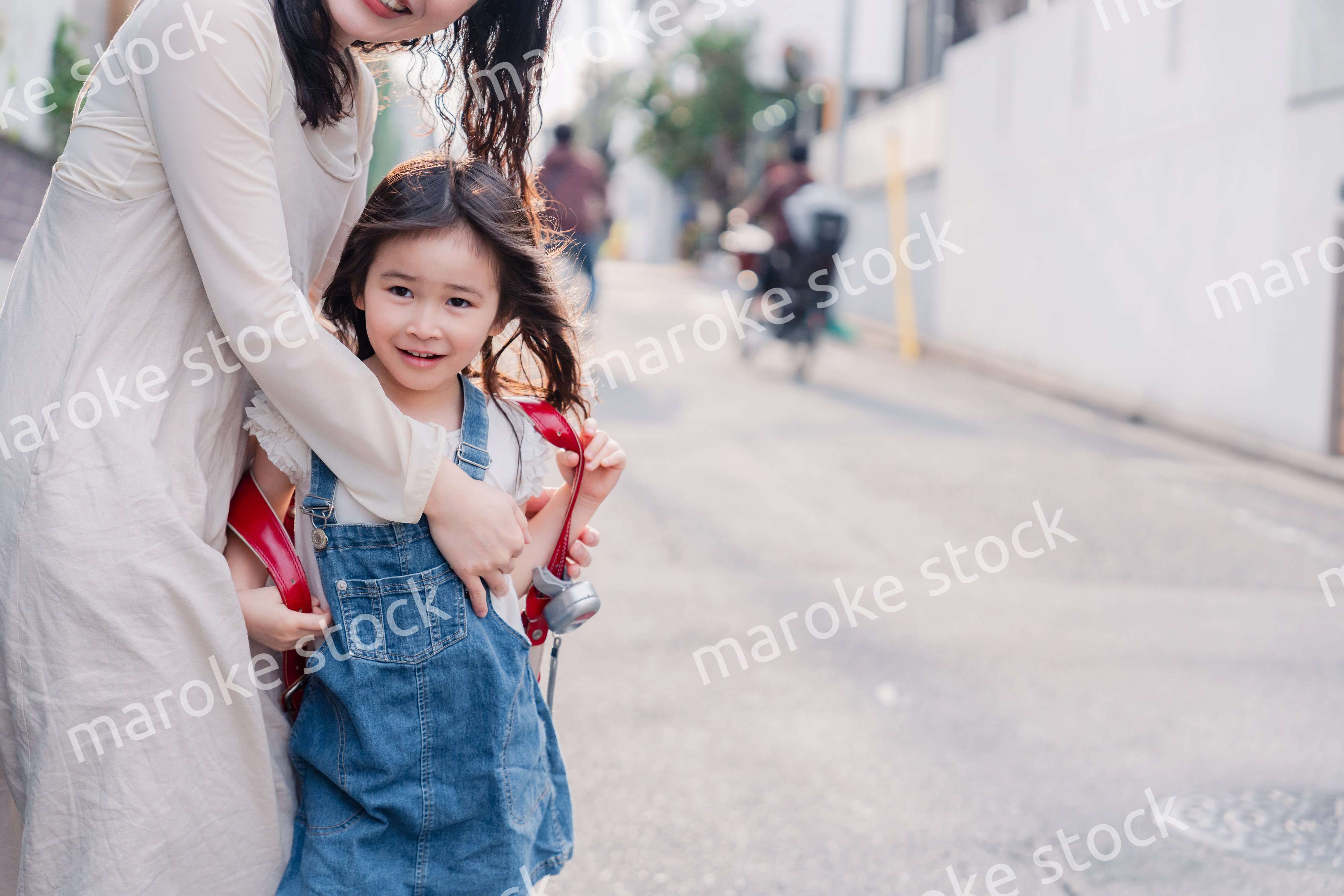 小学生の女の子のお迎えをするお母さん