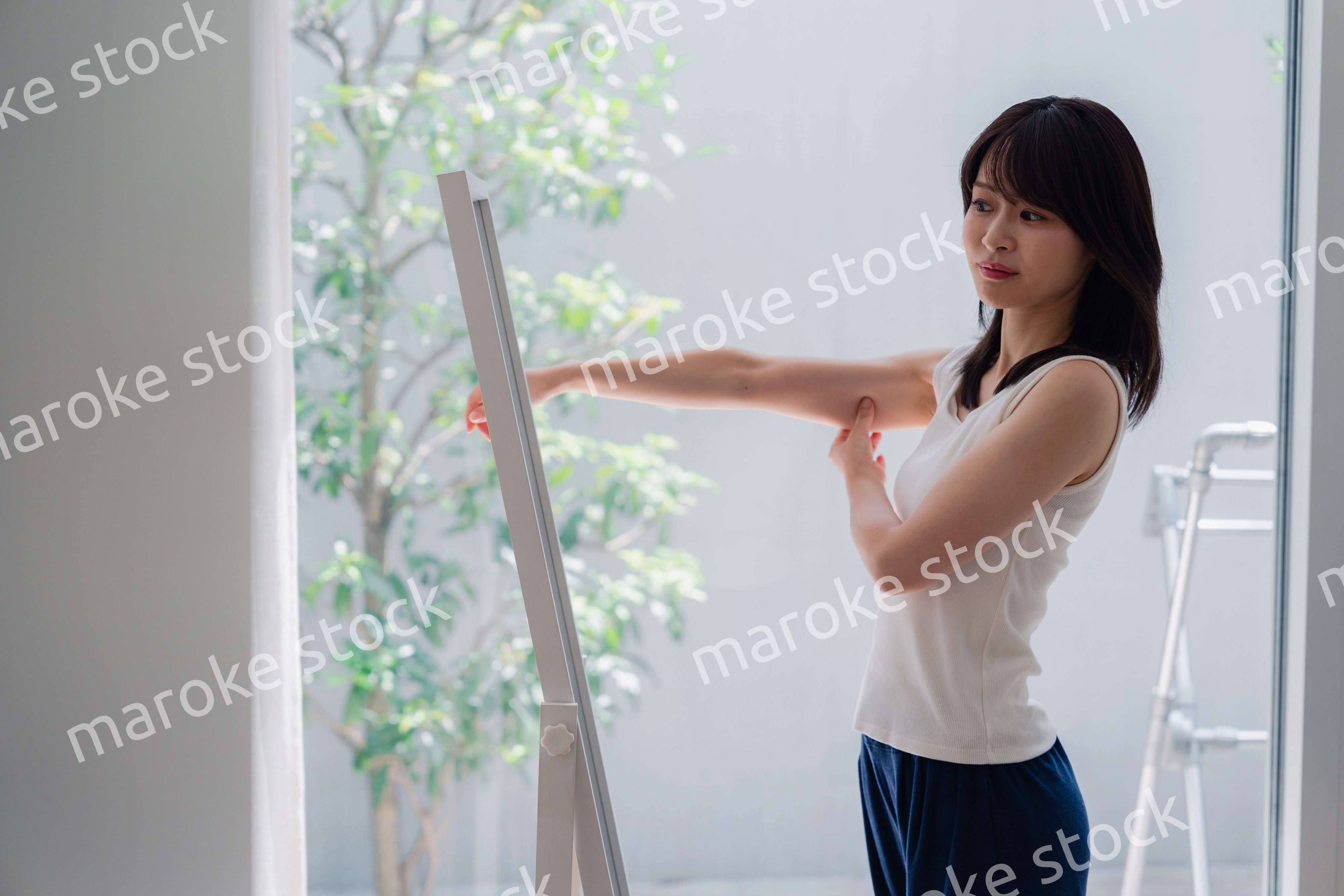 自分の体型を気にする若い女性