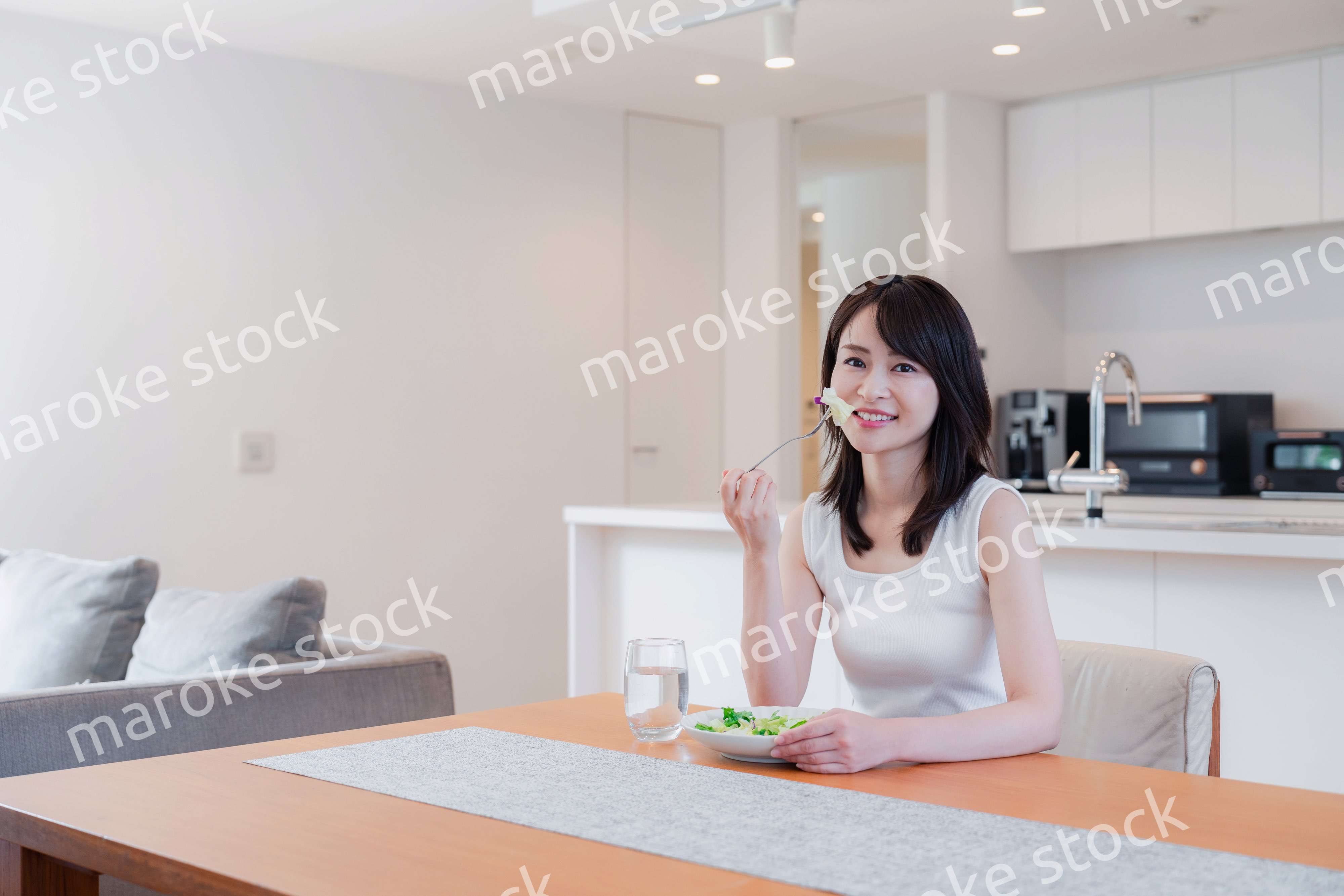 家でご飯を食べる若い女性