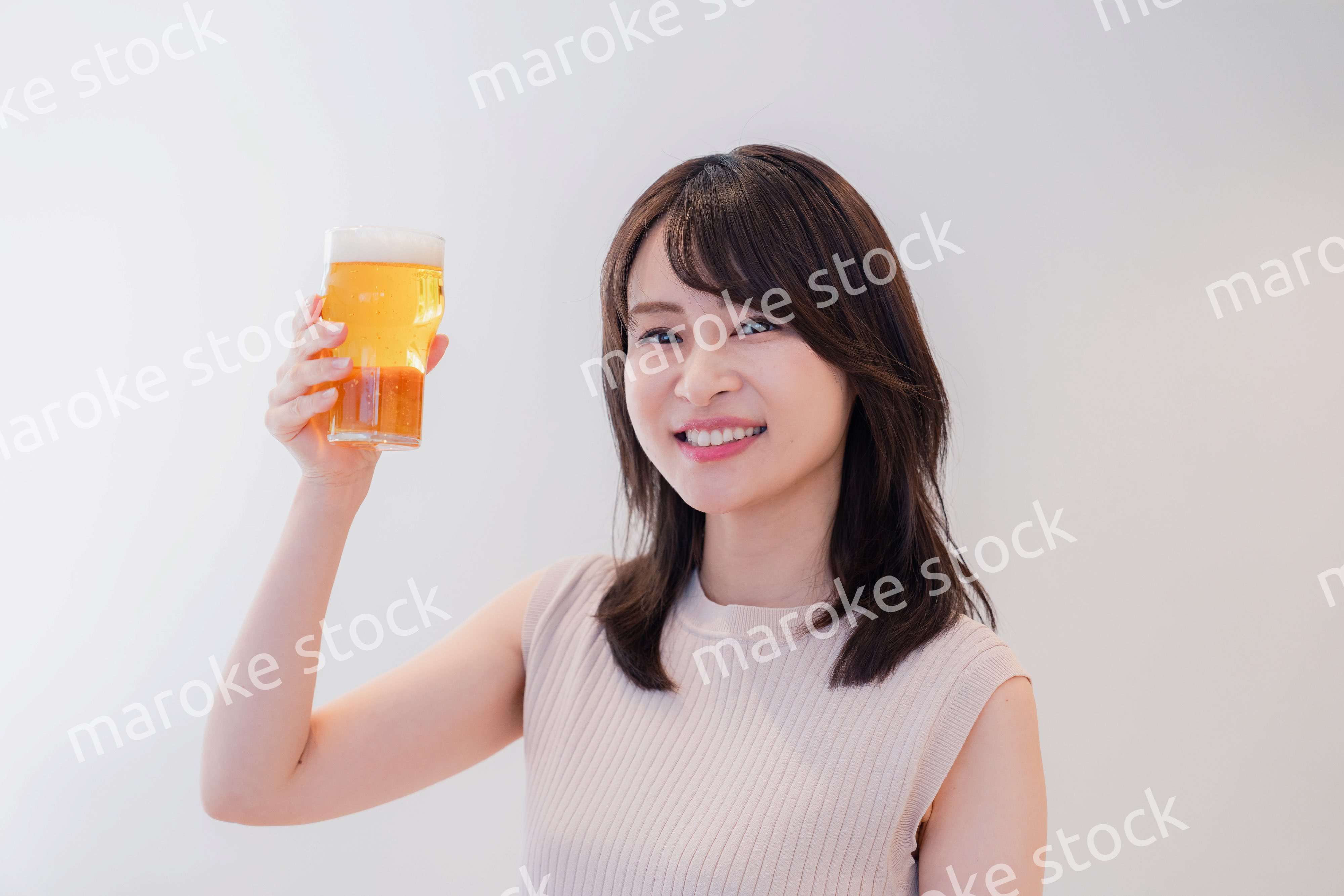 笑顔でビールを飲む若い女性