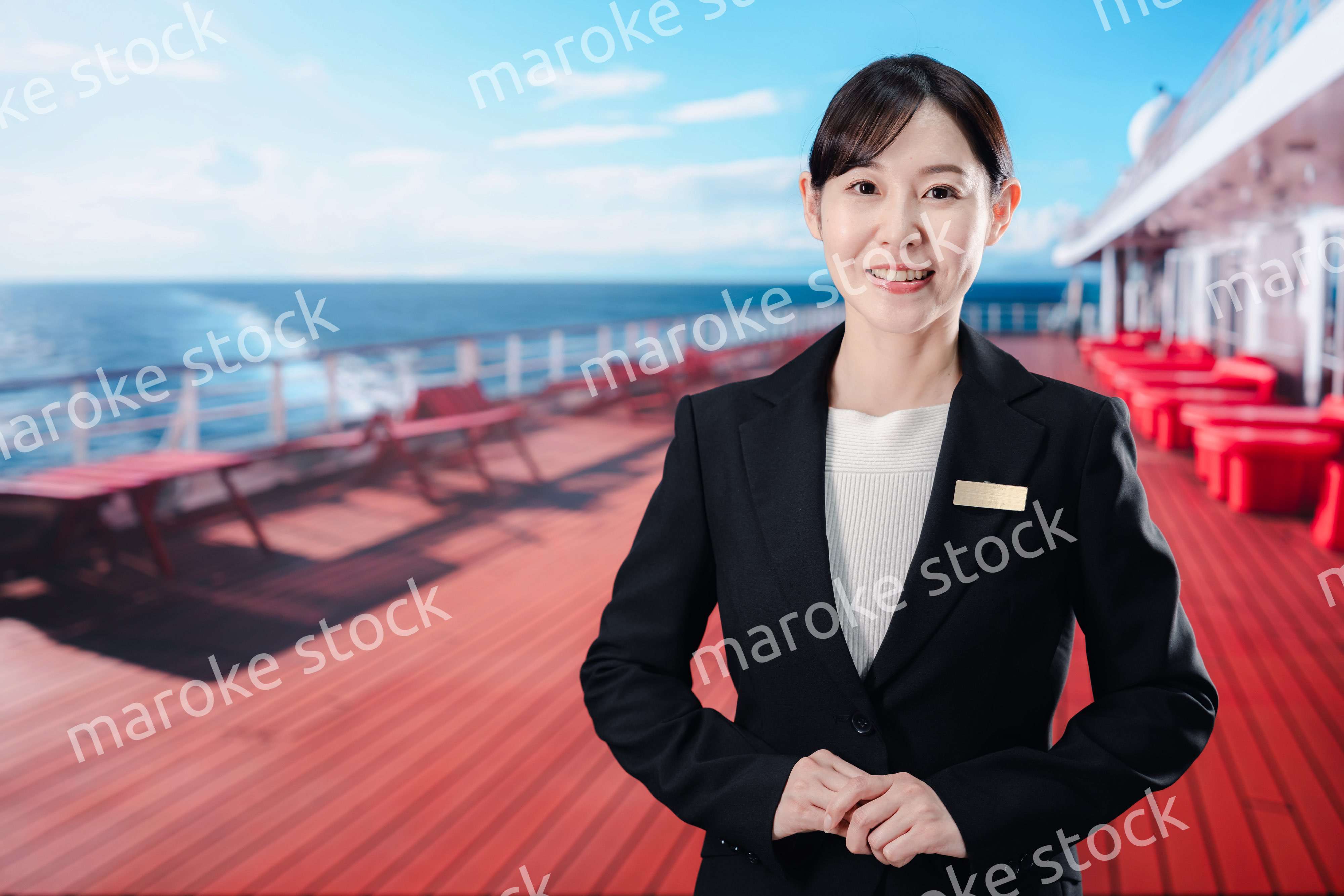 クルーズ船で乗船客を迎える女性船員