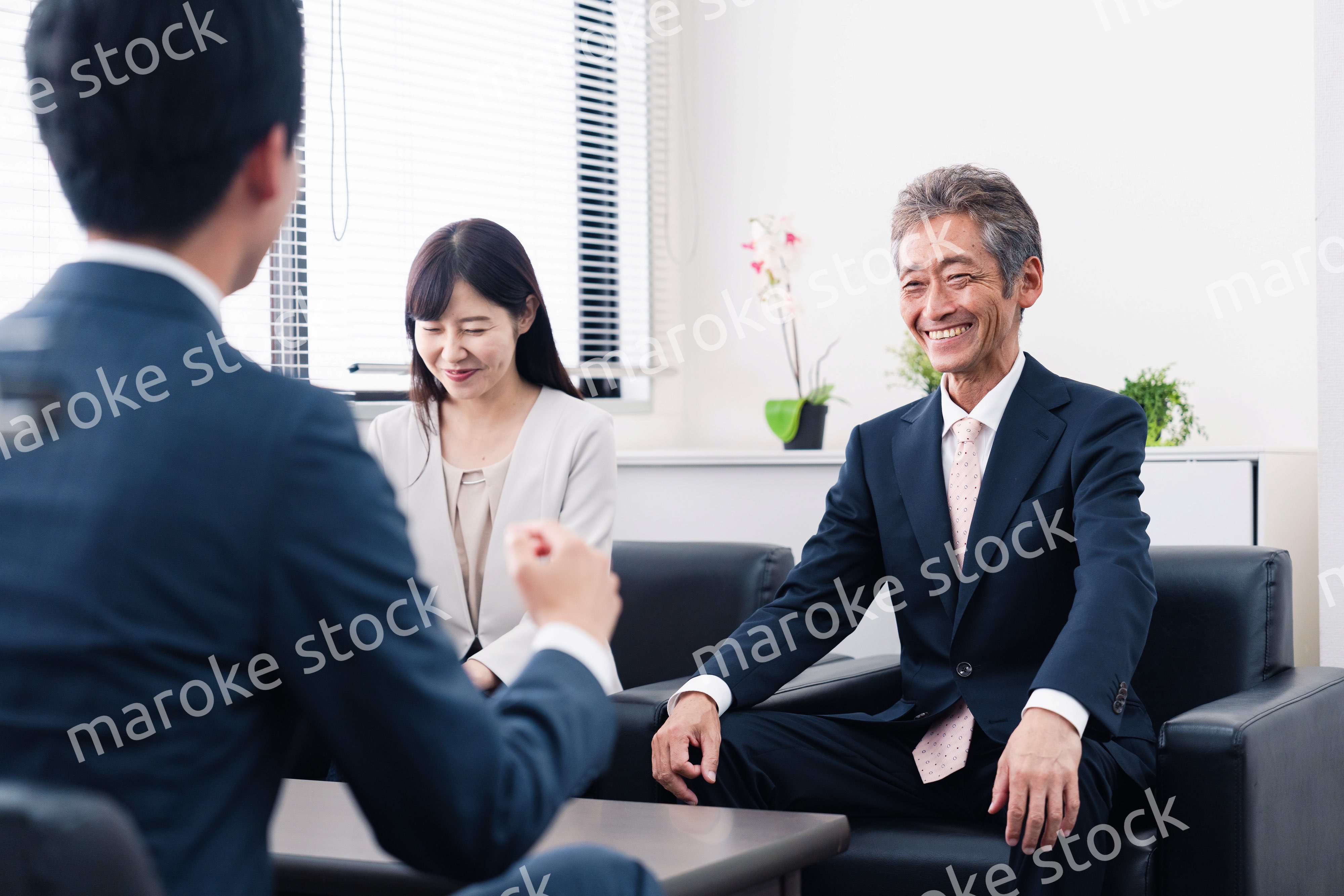 にこやかに商談をするビジネスパーソン