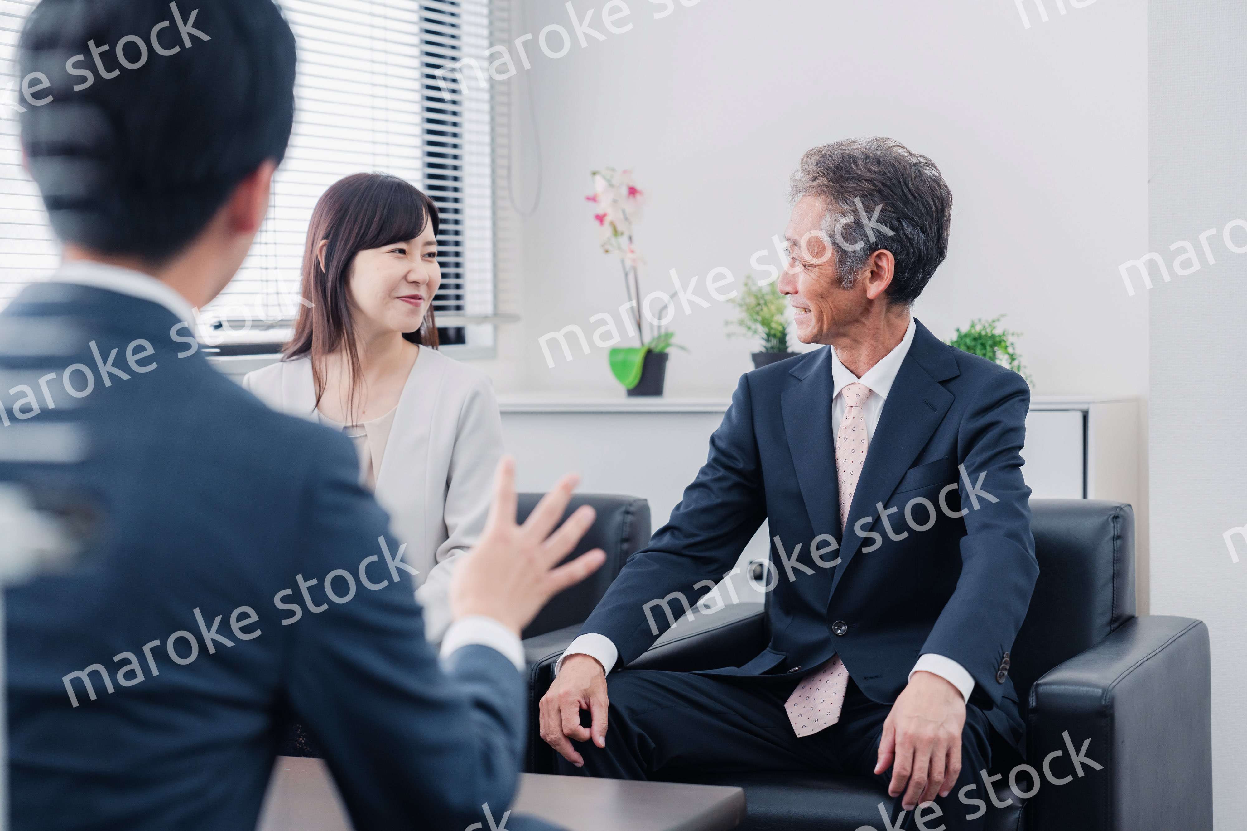 にこやかに商談をするビジネスパーソン