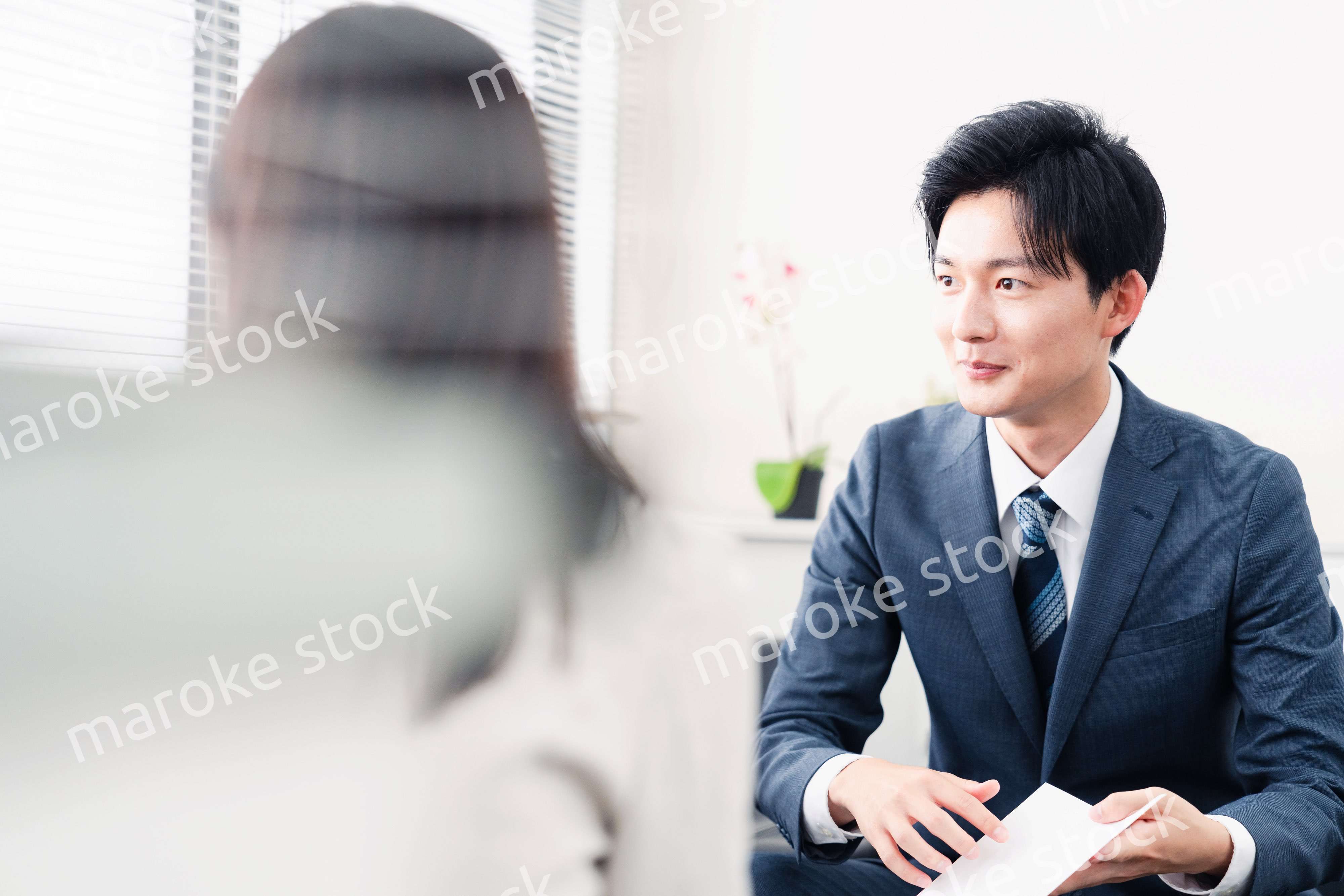 書類を提示する営業マン