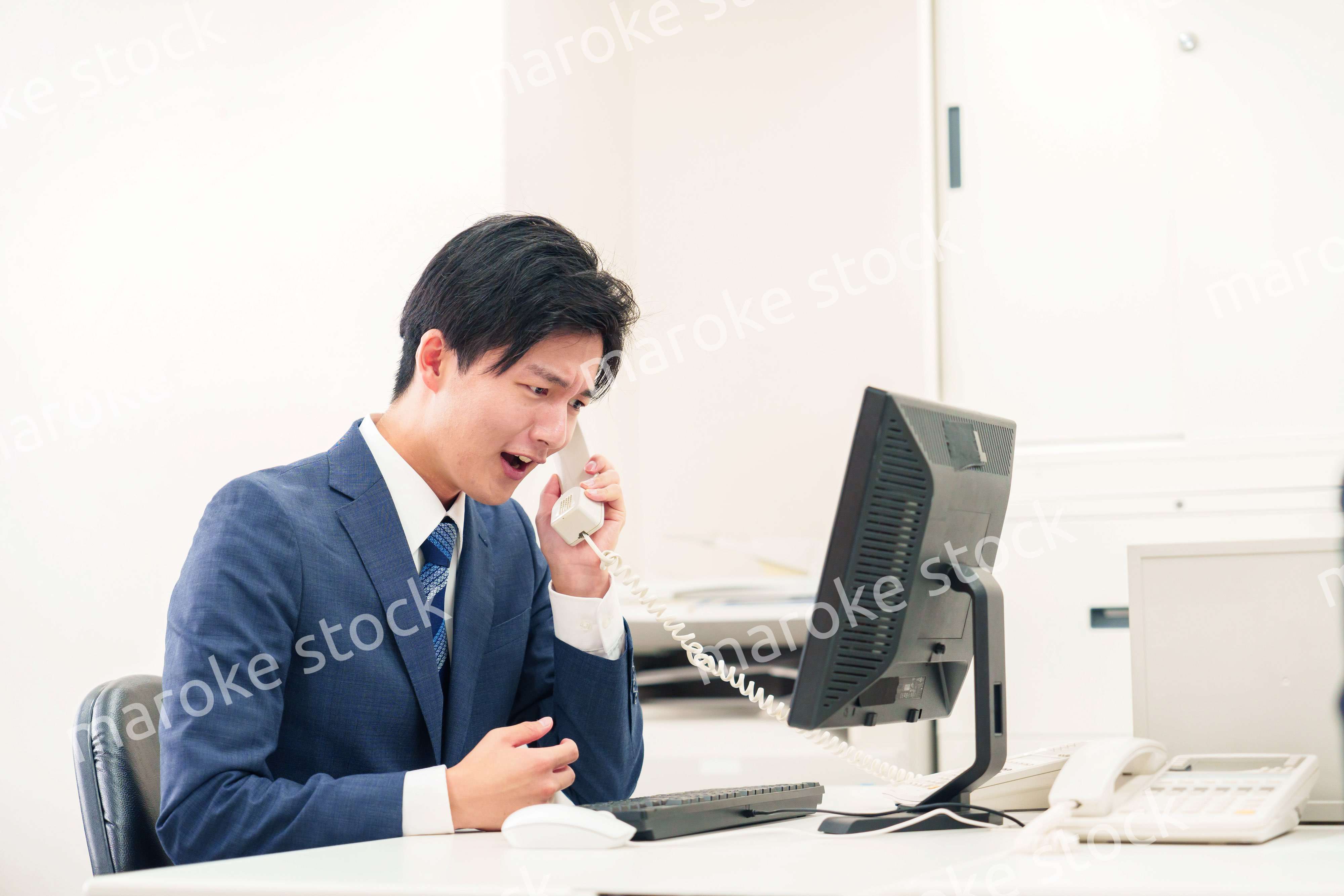 電話で怒鳴るビジネスマンの男性
