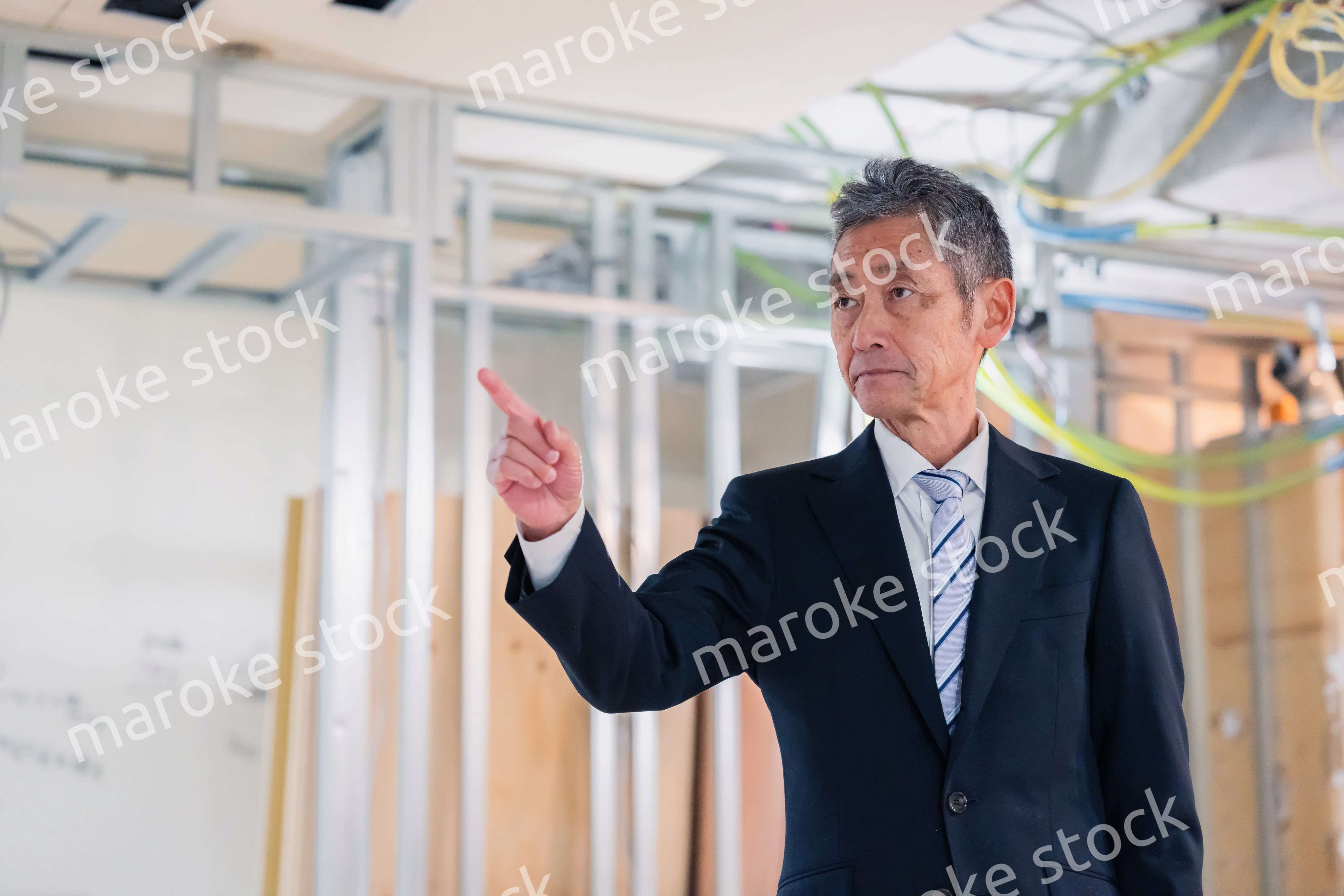 工事中の現場で指差し確認をする職人