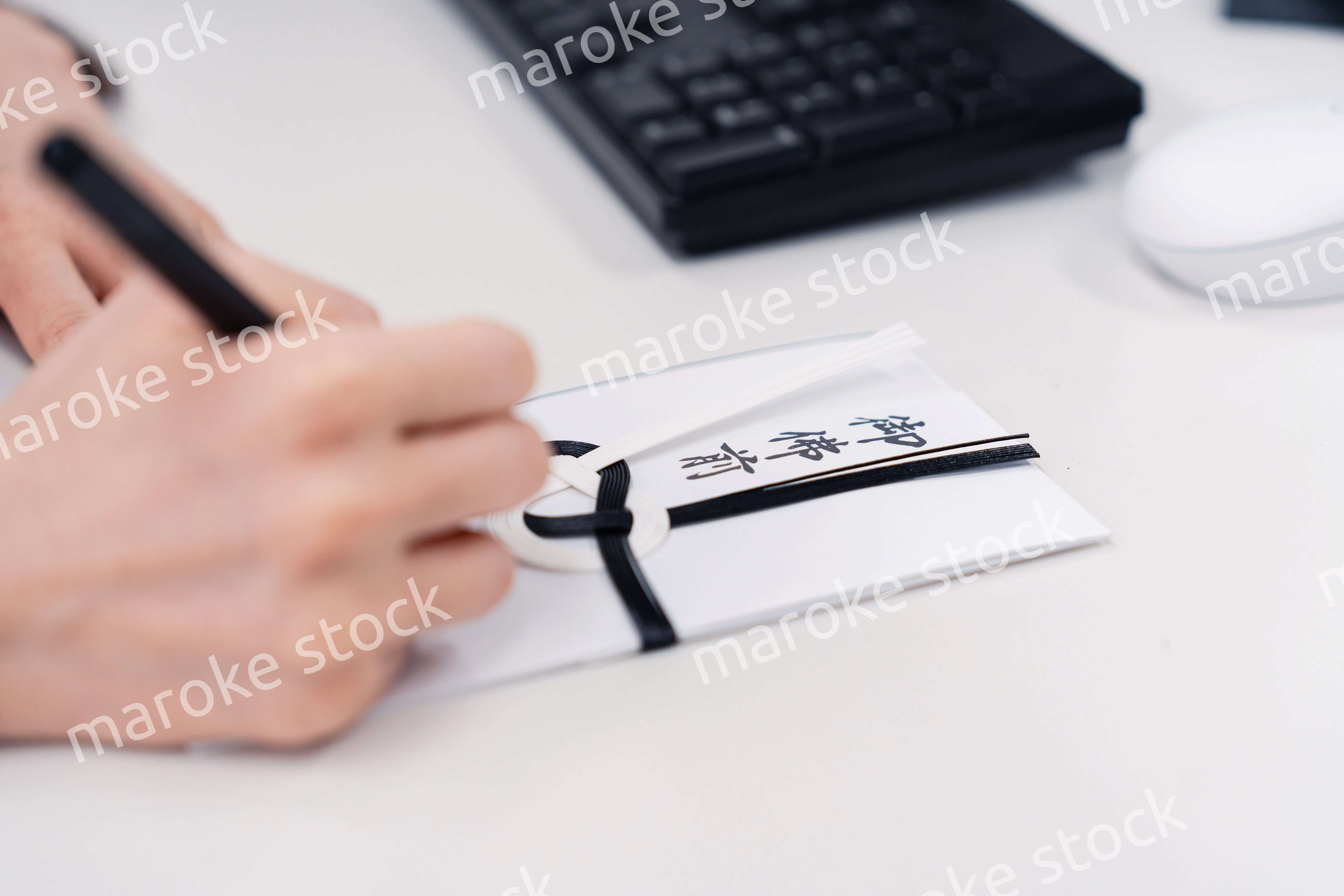 会社で葬儀の準備をする女性