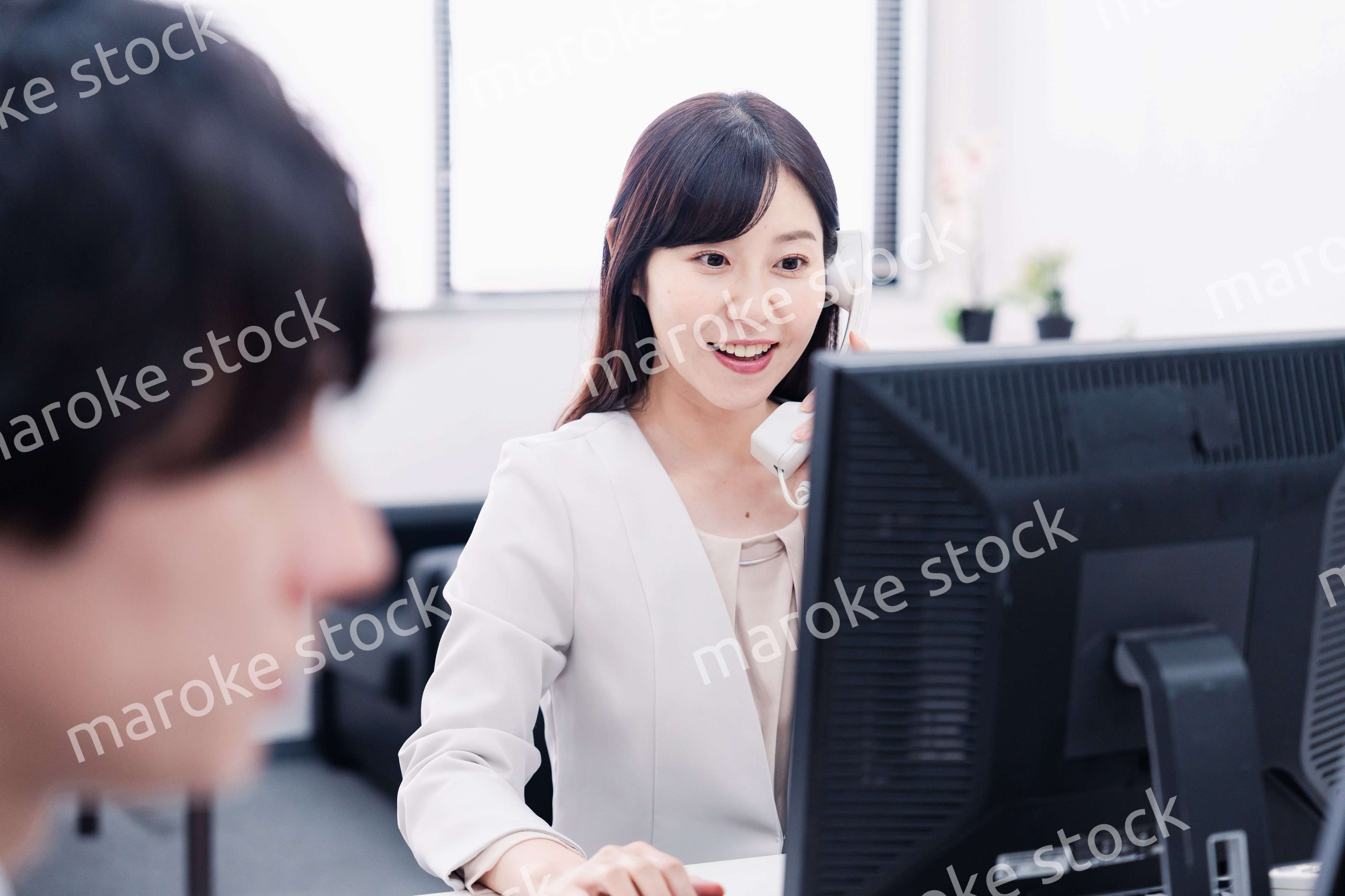 オフィスで電話対応をする女性社員