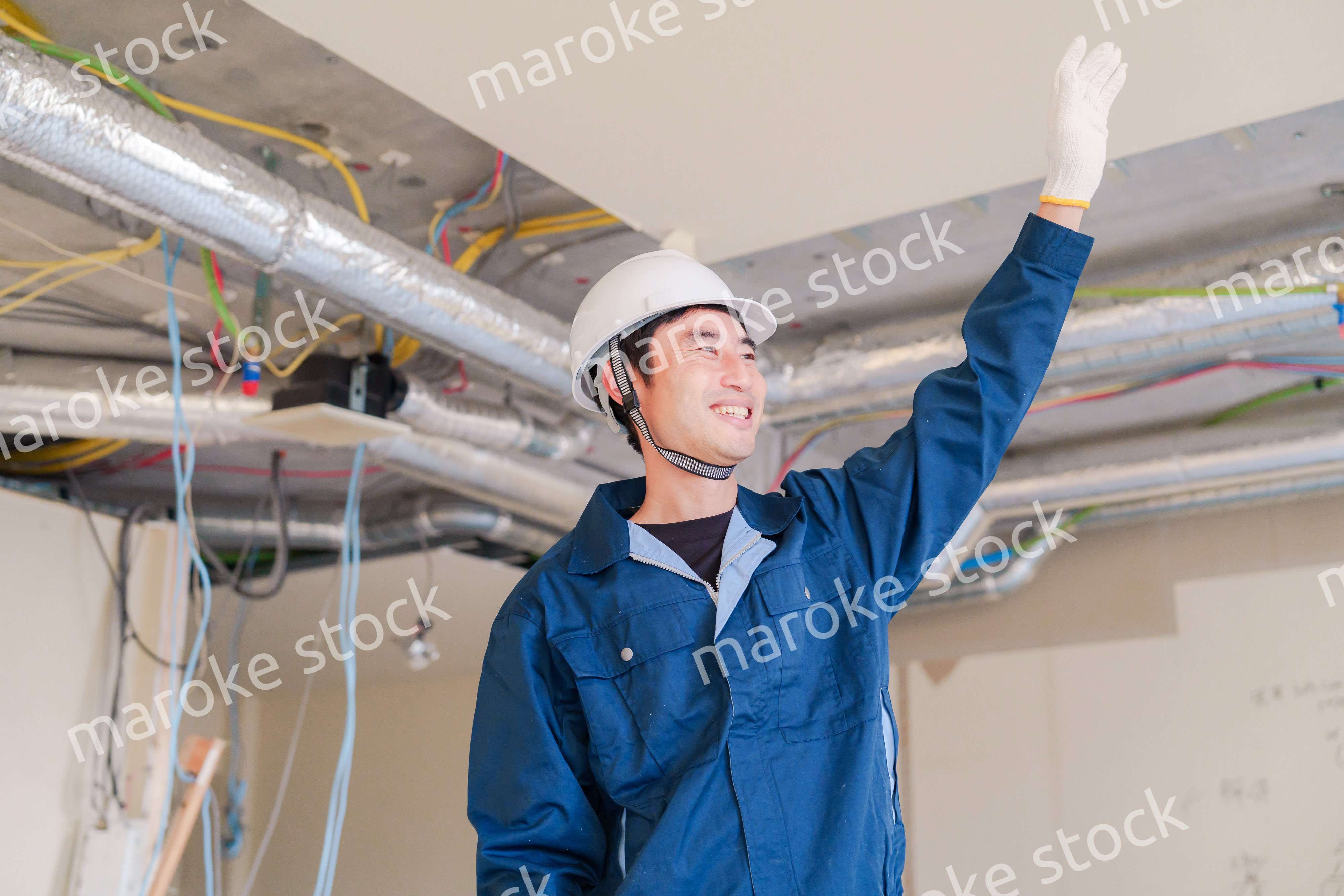 工事現場で楽しく働く職人の男性