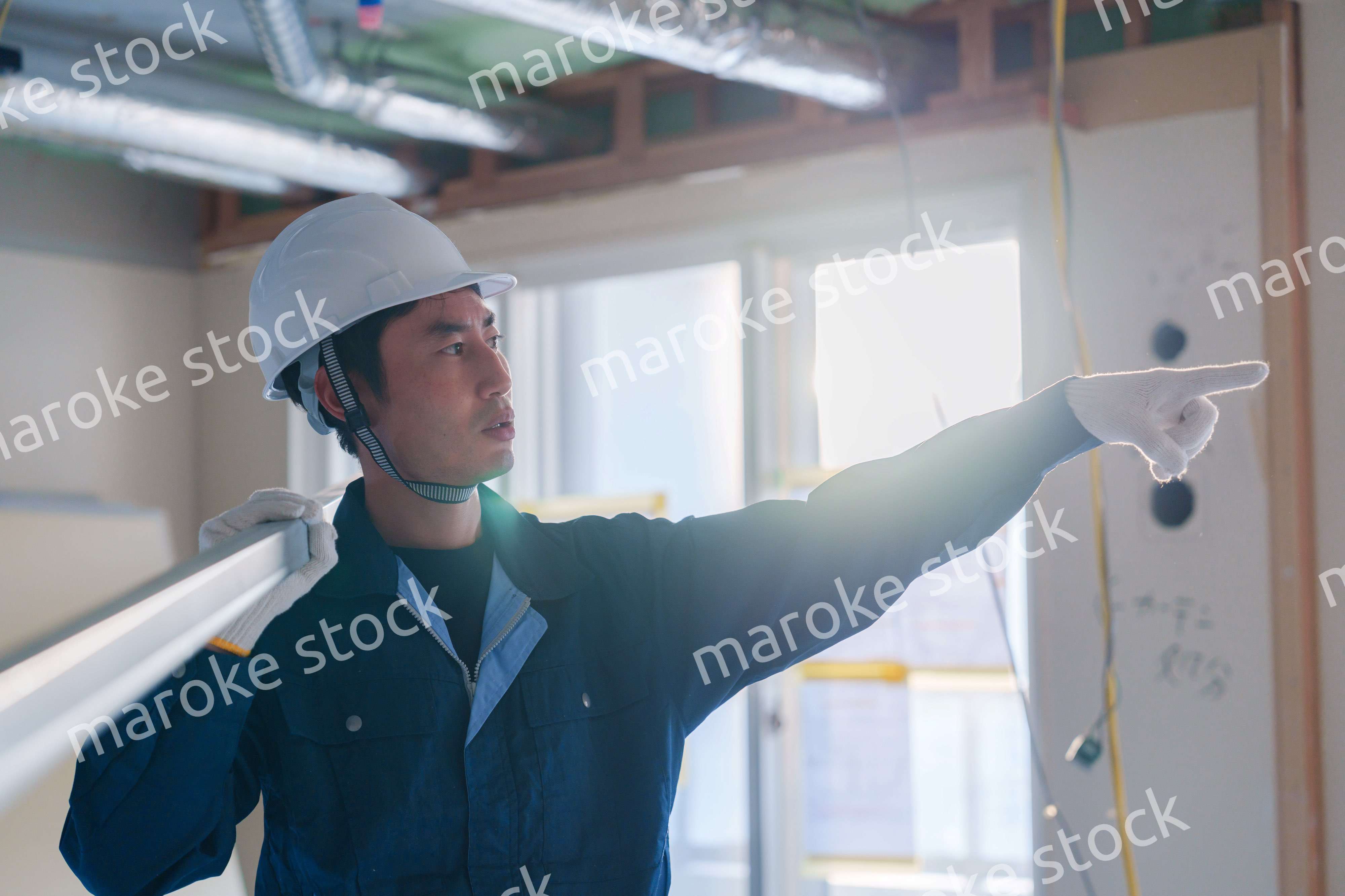 建設現場で資材を運ぶ男性の職人